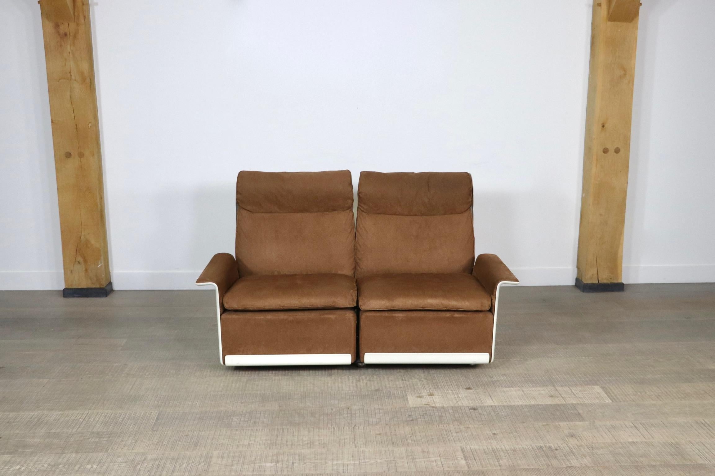Amazing model 620 two seater sofa in cognac alcantara upholstery and white frame, designed by Dieter Rams in 1962 for German manufacturer Vitsœ. The shells are made of A hot-pressed sheet moulding compound that sits on six chromed wheels. This