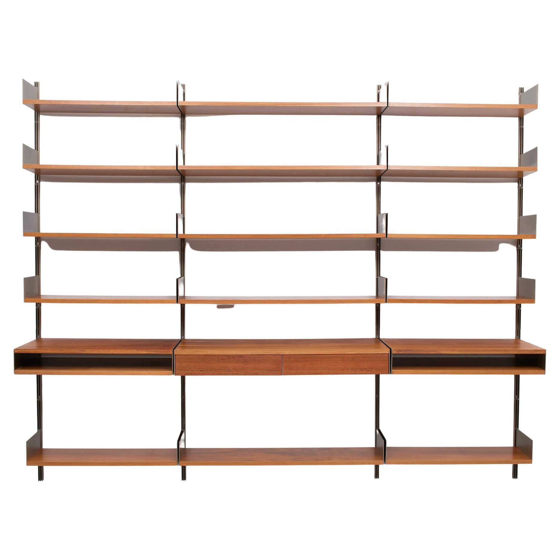 Beautiful wall unit, Comes in warm Walnut color. Bronze color rails and high bookends at the end of each shelf. Can be Adjust to your personnel taste. 6 rails 15 shelves and 3 units one with 2 drawers.
Very nice condition. Designed by Dieter Rams
