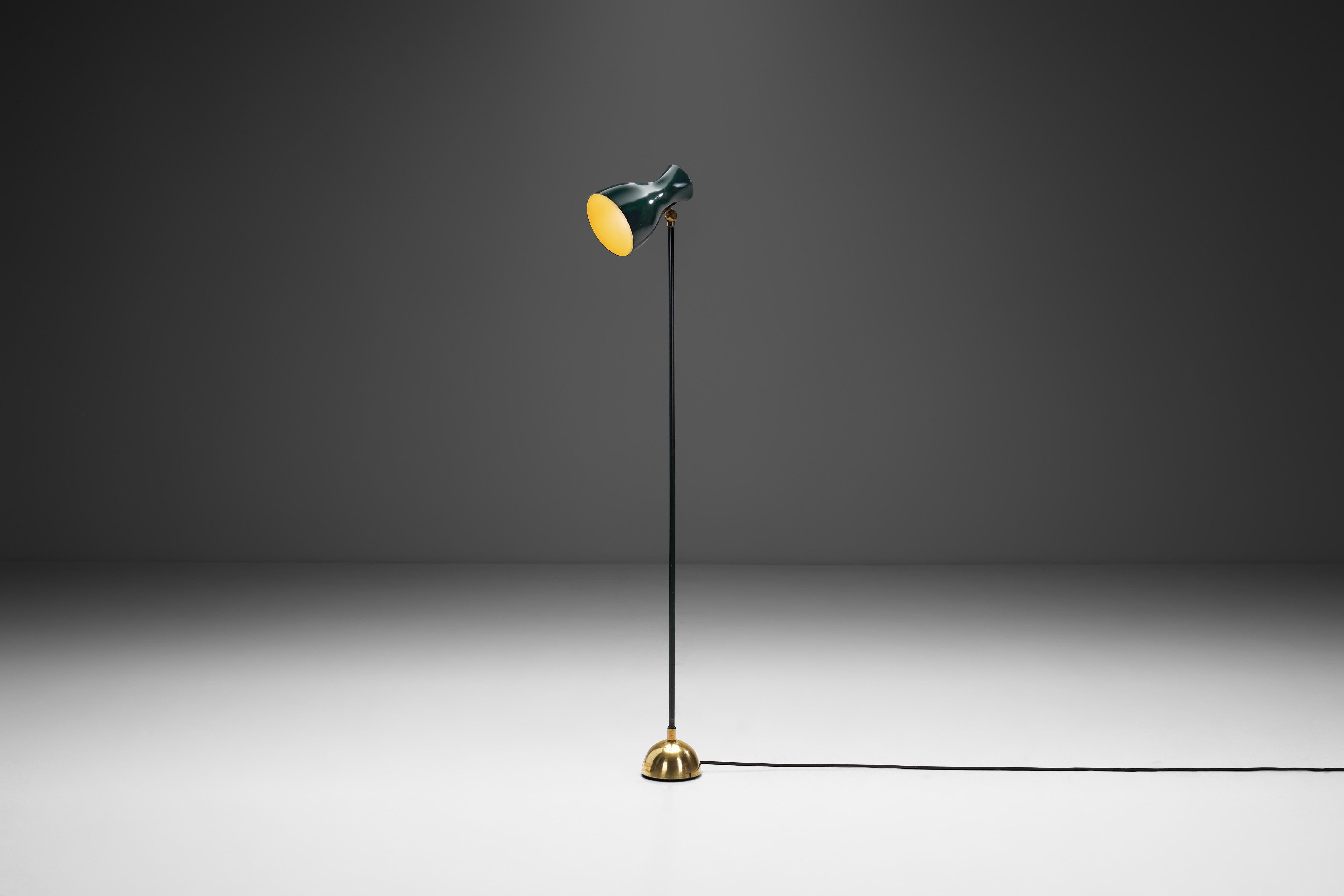 This Dieter Schulz Model “No. 57/4 16” floor lamp is a timeless design piece created in 1957 for the Swiss company, Wohnbedarf AG Schweiz. Crafted from black enamelled metal and brass, this luminary exemplifies the quintessential mid-century