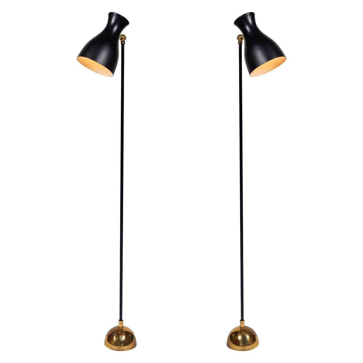 Dieter Schulz Model No. 57/4 16 floor lamp for Wohnbedarf AG Schweiz, 1957. Executed in black enameled metal and brass. A quintessentially midcentury European design that is highly functional and incomparably refined. Reminiscent of and often