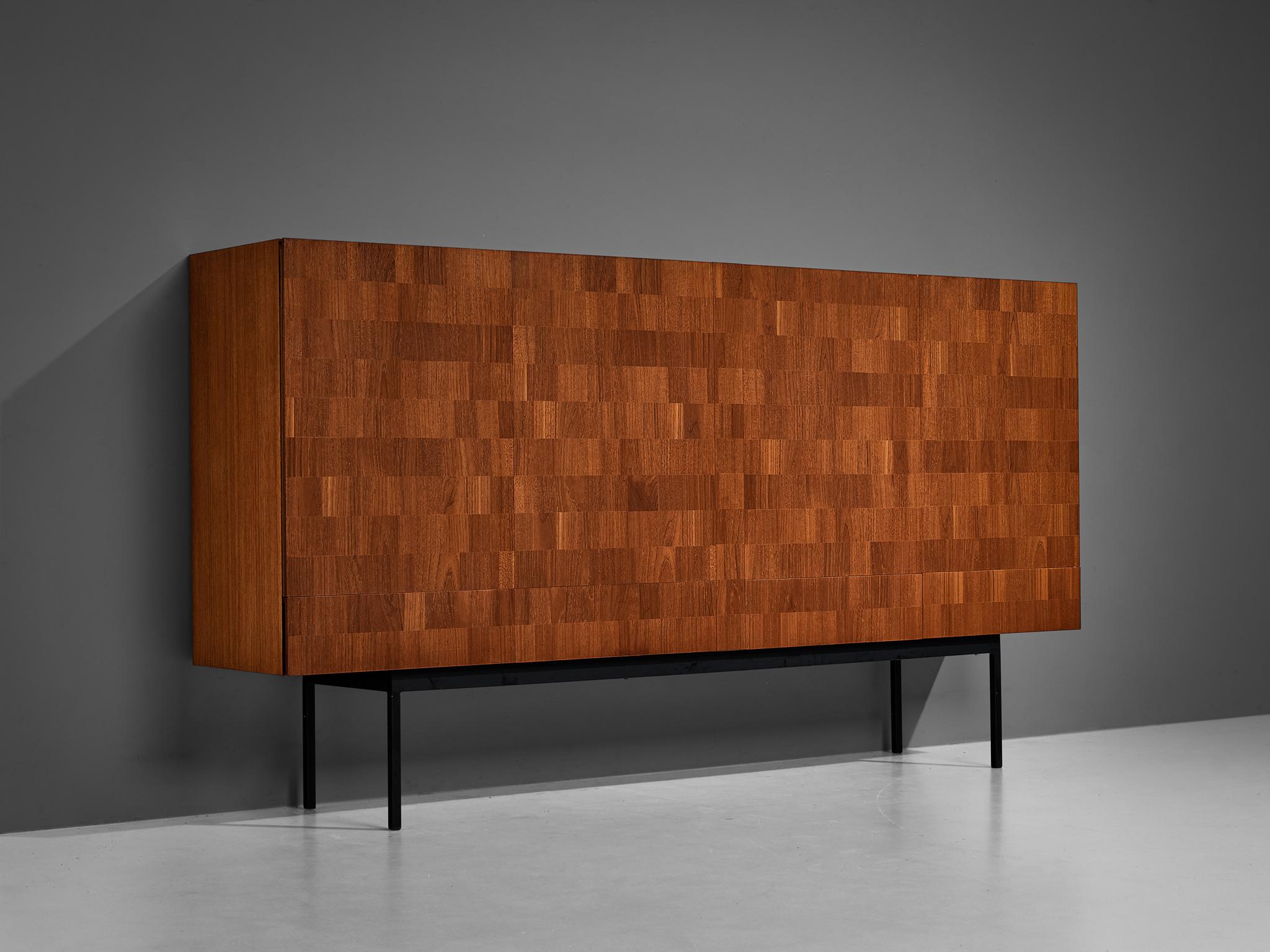 Dieter Waeckerlin for Behr, sideboard, teak, metal, maple, Switzerland, 1950s.

This distinctive sideboard holds an utterly well-balanced construction embracing a great sense of proportions. The whole design is based on an elongated body executed in