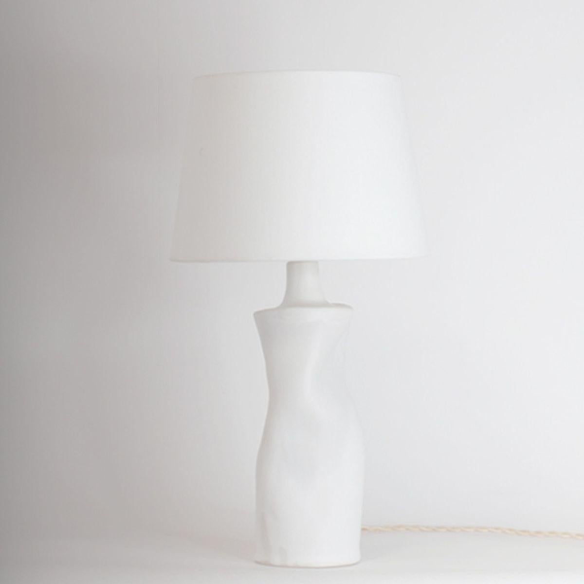 'Difforme' white ceramic table lamp with parchment shade by Design Frères.

Wired with high-end twist cord and 3-way switch (on, half intensity, off). A 40w filament bulb is included in your order. The European style parchment shade (no harp or