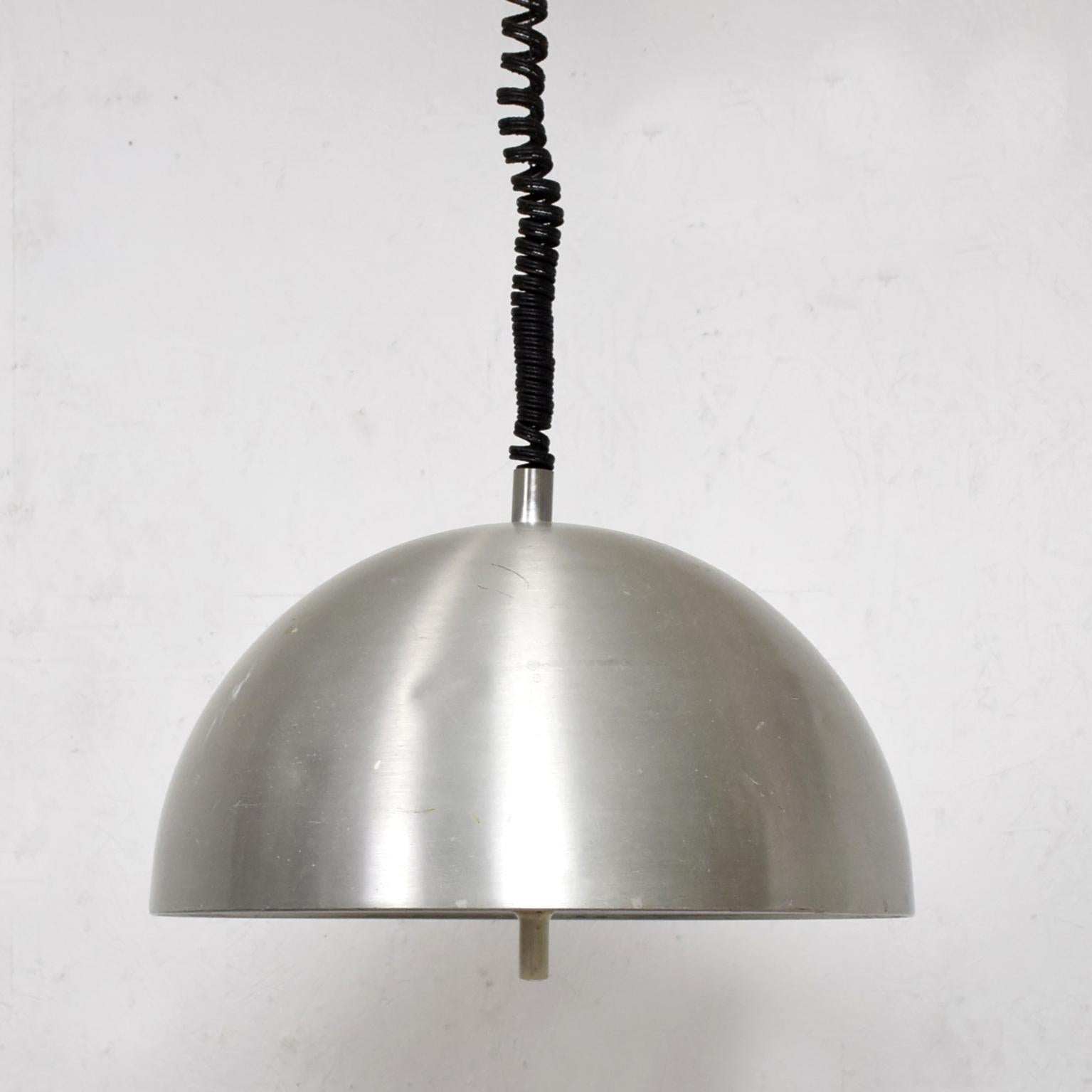 Pendant Ceiling Lamp
Italian Pendant Ceiling Lamp Light Milan Italy circa 1960s attributed to Stilnovo
Diffused silver dome made in aluminum and plexiglass lamp is adjustable black mount. 
Unmarked.
29 H x 15.5 W x 8 D   
Original Unrestored vintage