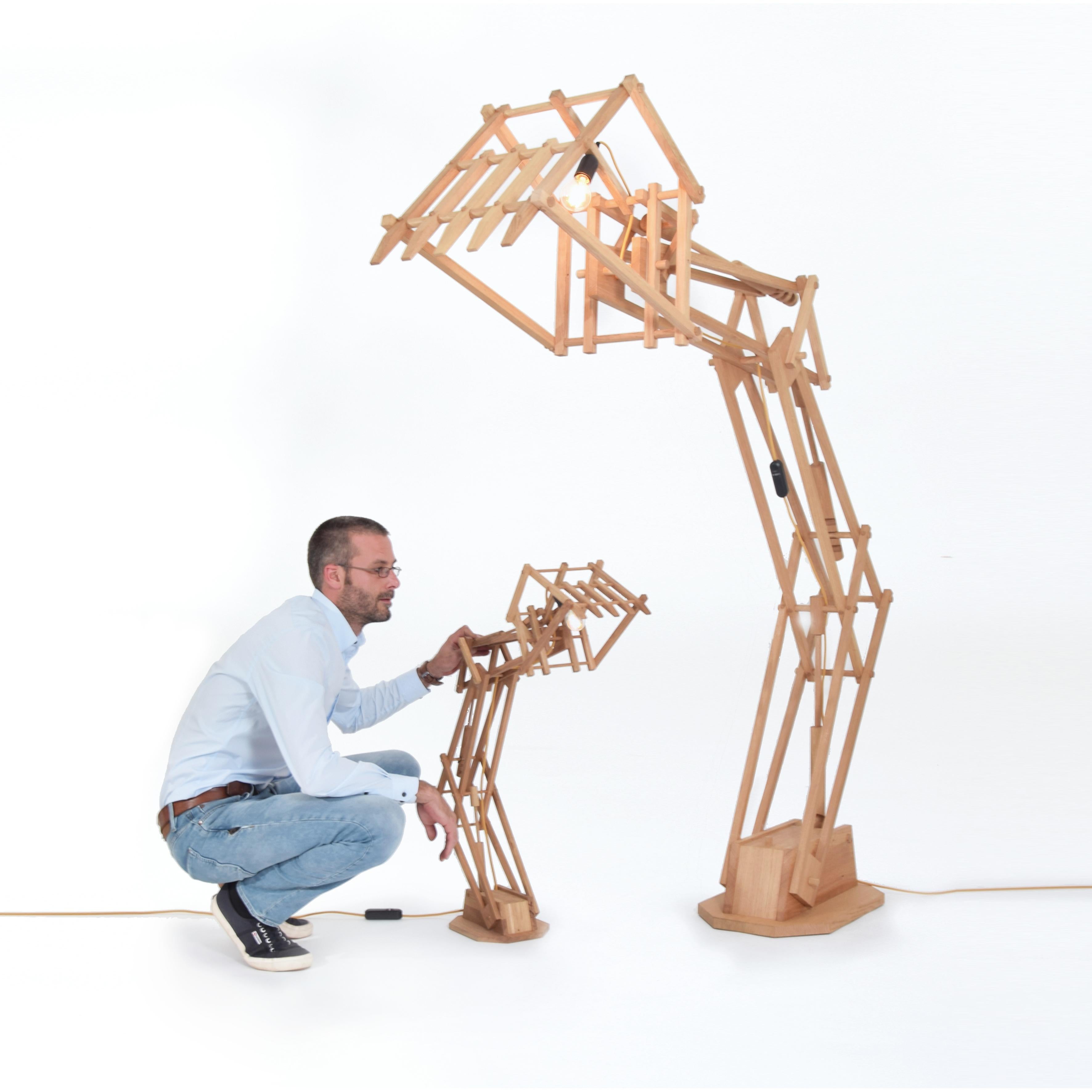 Digit lamp desk by Studio Pin
Dimensions: D 85 x W 21 x H 76 cm 
Materials: Solid oak. 
Weight: 6 kg
Content: LED dimmer, E14 fitting

Try hard, dig deep, they said. Can you dig it? This digger is a handmade light fixtures made out of reused