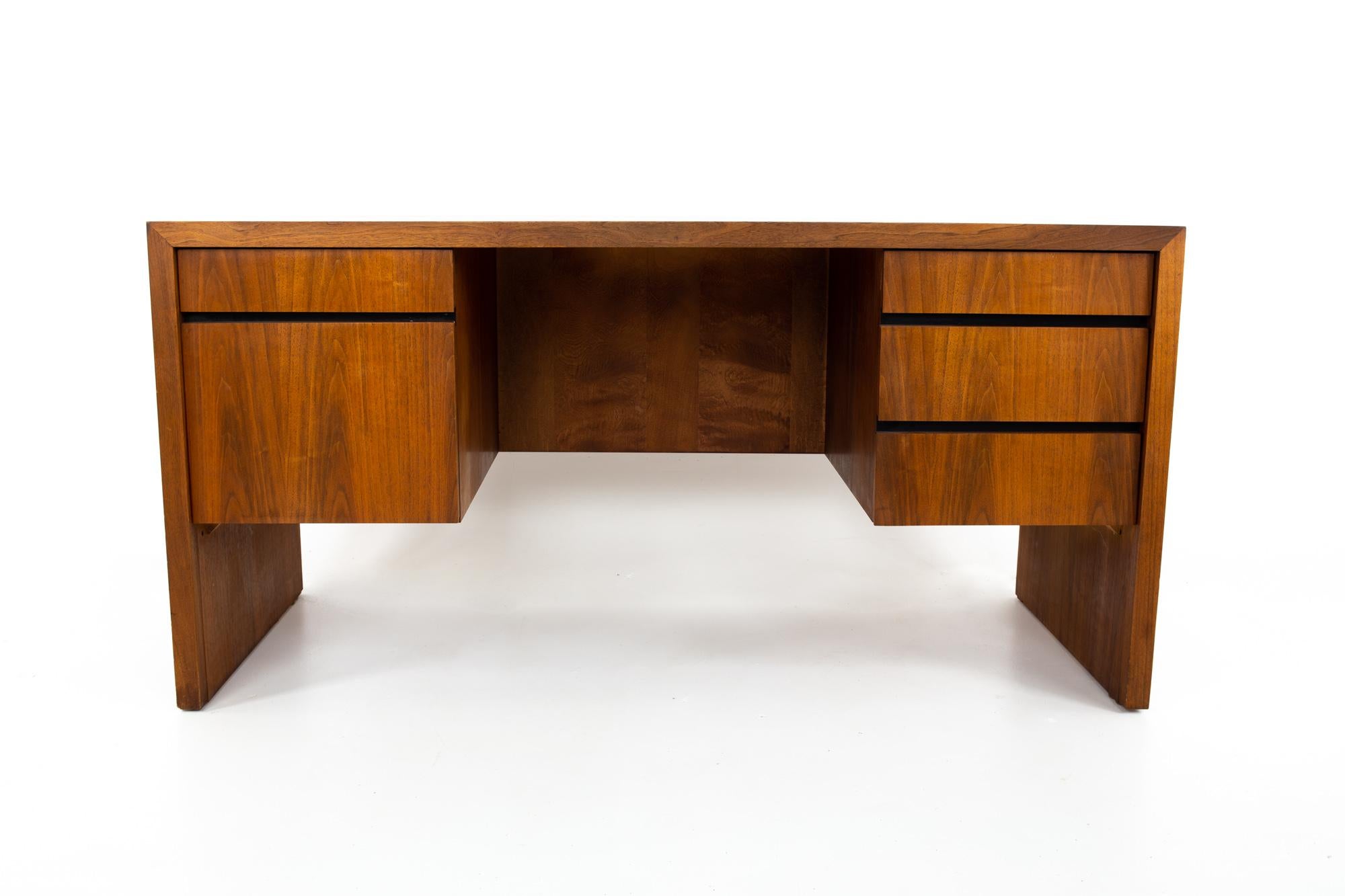 Dillingham Mid Century walnut executive desk.
Desk measures: 60 wide x 26 deep x 30 inches high

All pieces of furniture can be had in what we call restored vintage condition. This means the piece is restored upon purchase so it’s free of