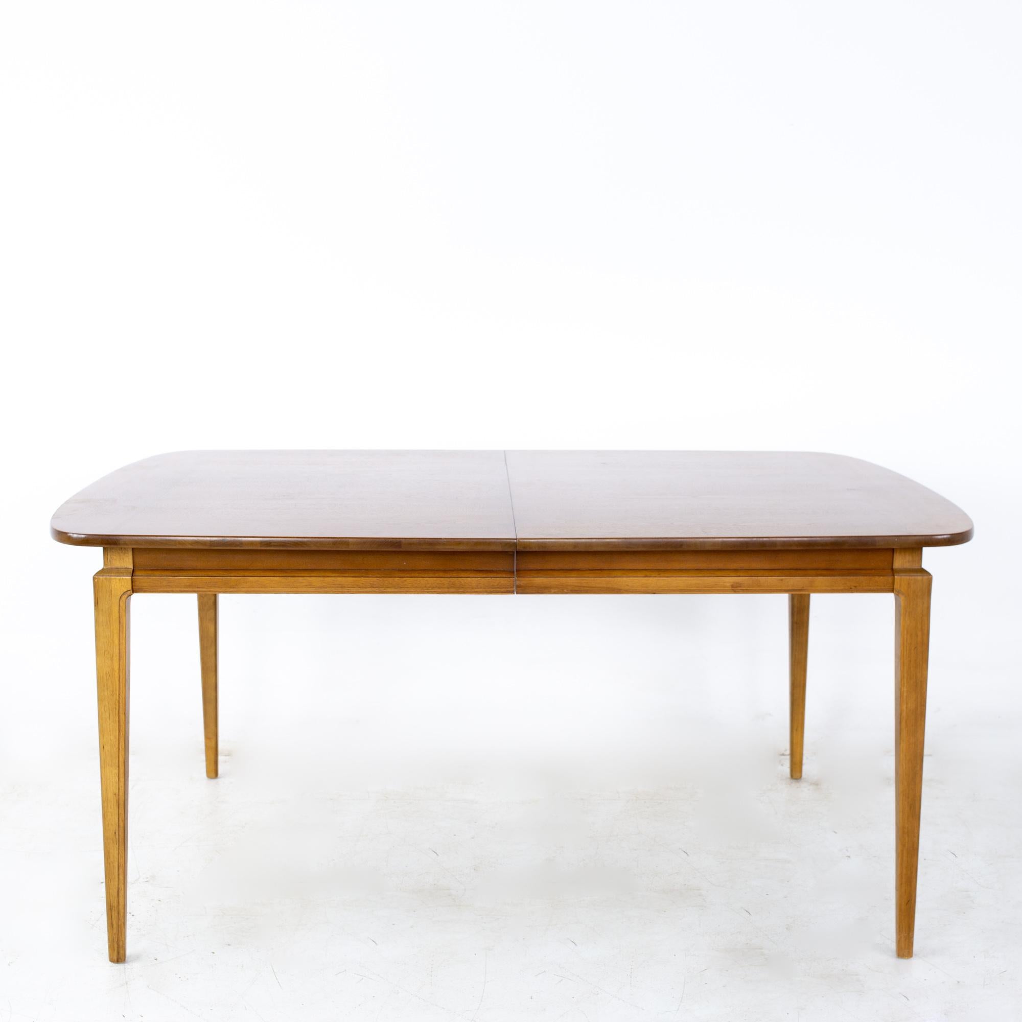 Dillingham style mid century walnut expanding 10 person dining table
Table measures: 62.25 wide x 42 deep x 29.25 inches high; each leaf is 18 inches wide, making a maximum table width of 98.25 inches when both leaves are used and has a chair