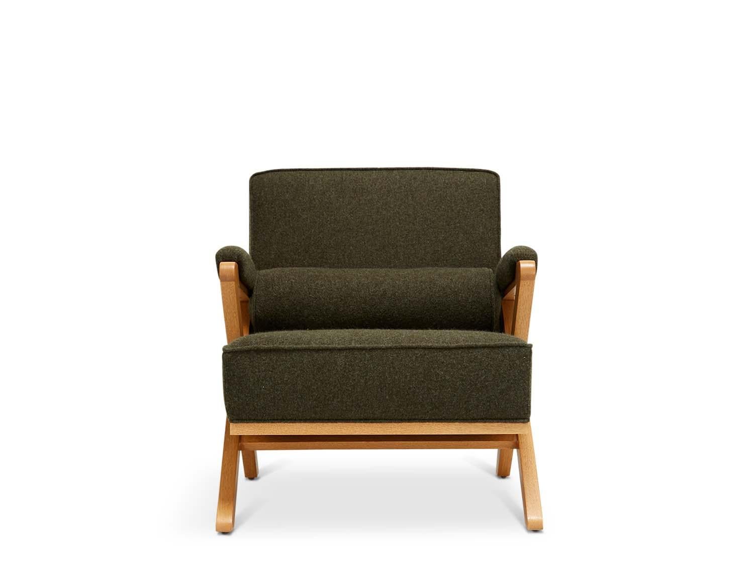 The Dillon chair has a solid American walnut or white oak x-based frame that features boxed cushions with piping and buttons on the back cushion. 

 