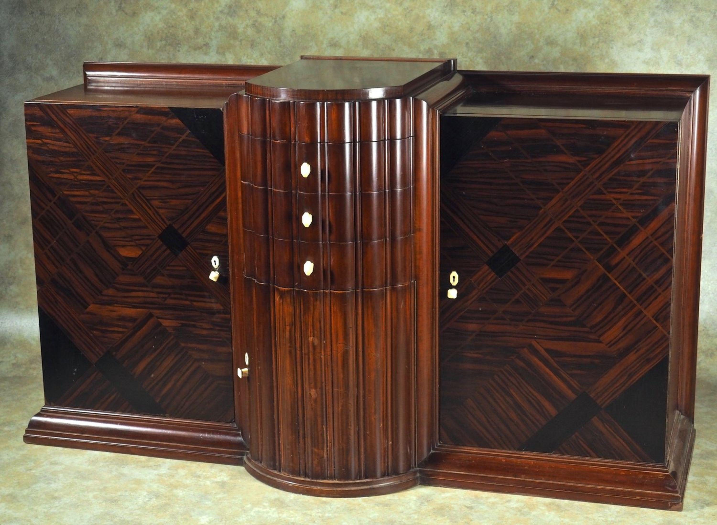 French Modernist Art Deco cabinet by DIM (Joubert et Petit) in rosewood and mahogany, with Bakelite escutcheons and pulls. Model presented at the 1926 Salon des Artistes Decorateurs in Paris and pictured in the exhibition portfolio. Measures: 70