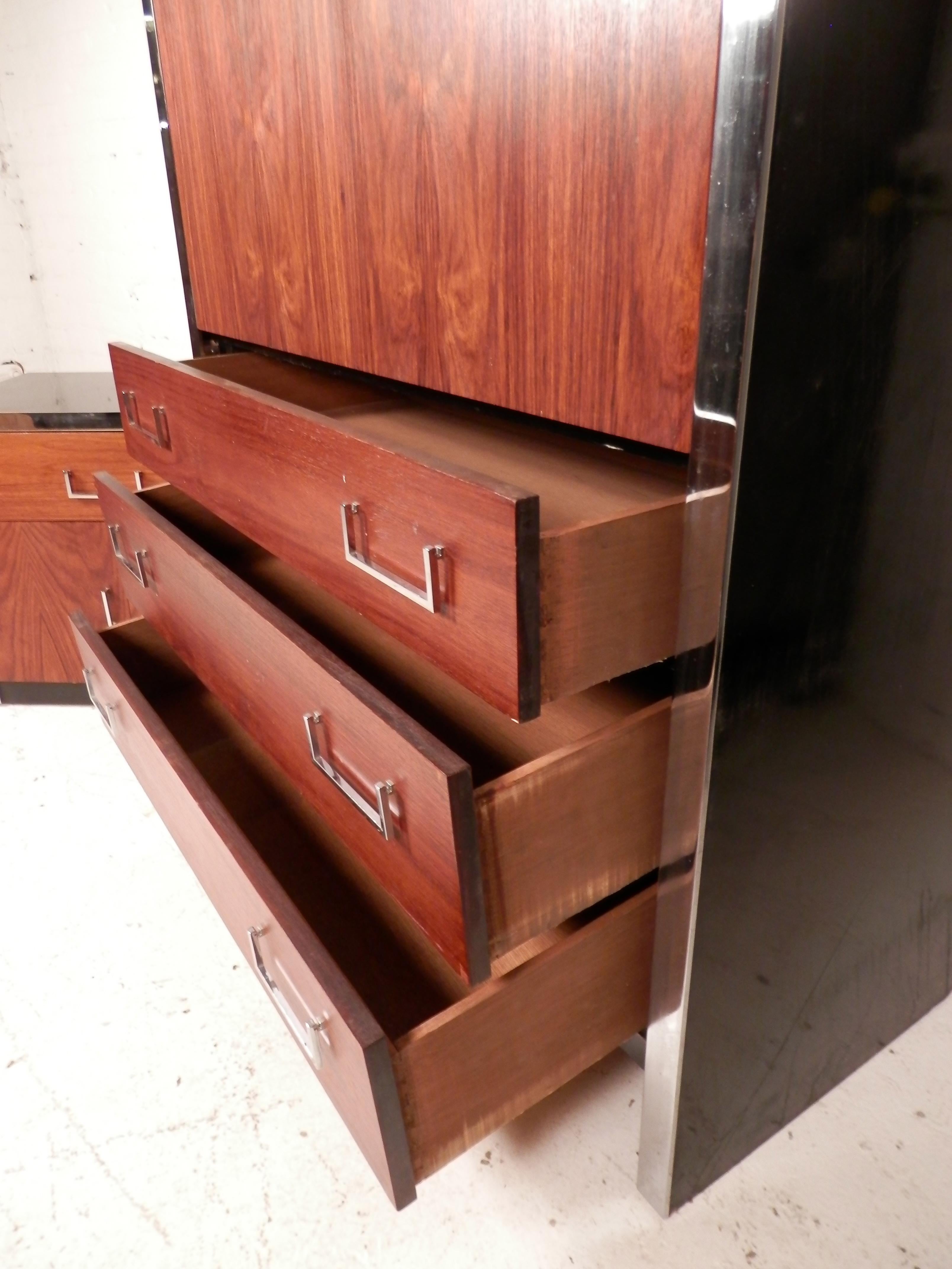 Tall Mid-Century Modern cabinet with rich rosewood veneer and polished chrome accents. Part of the 3500 series from West Michigan Furniture's Dimension 1 line. Great design for modern homes.
Please confirm location.