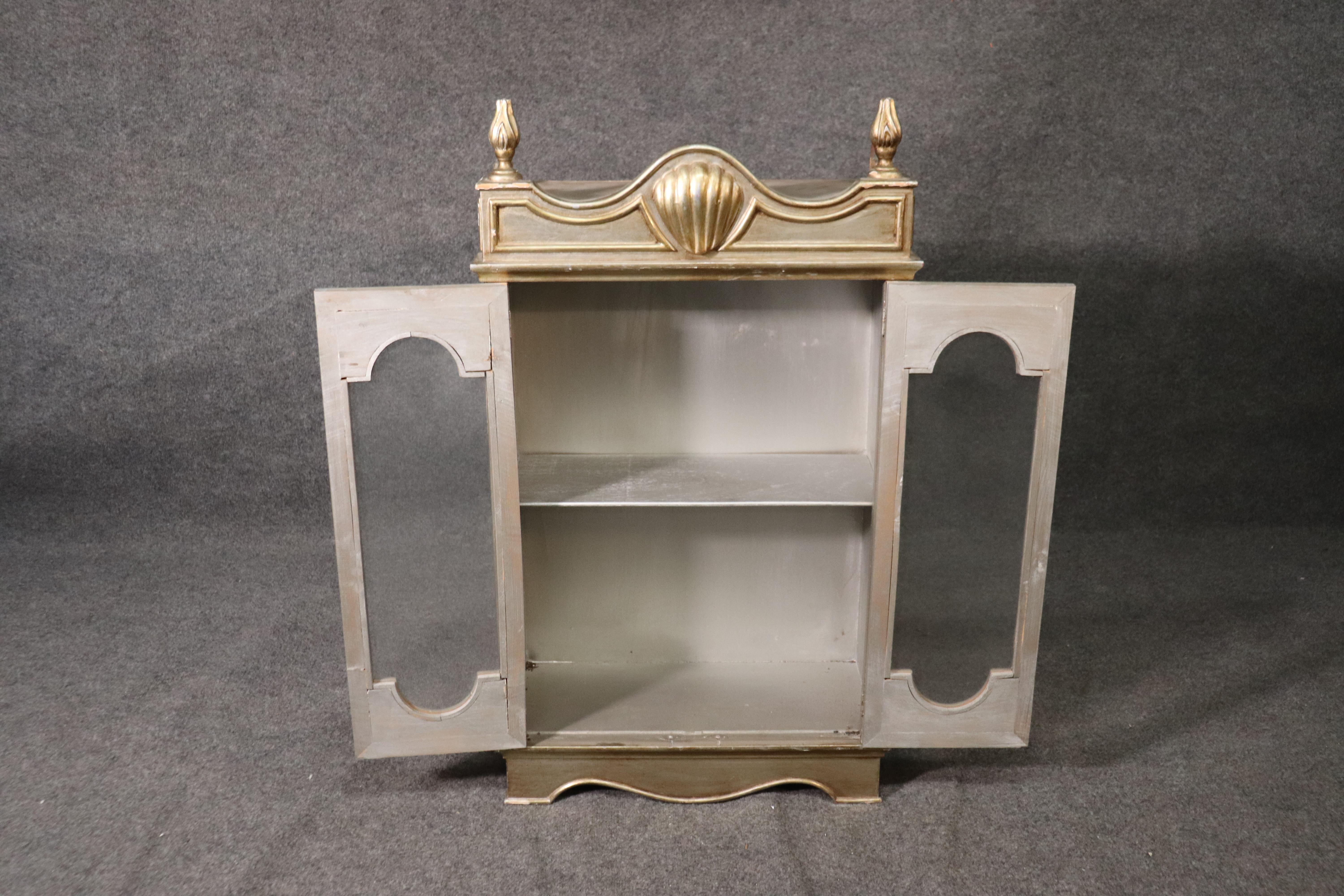 This is an Italian silver leaf cabinet dating to the 1950s era and measures: 40 tall x 23 wide x 10 inches deep. The cabinet is in good vintage condition and has minor age related wear. Nothing significant.