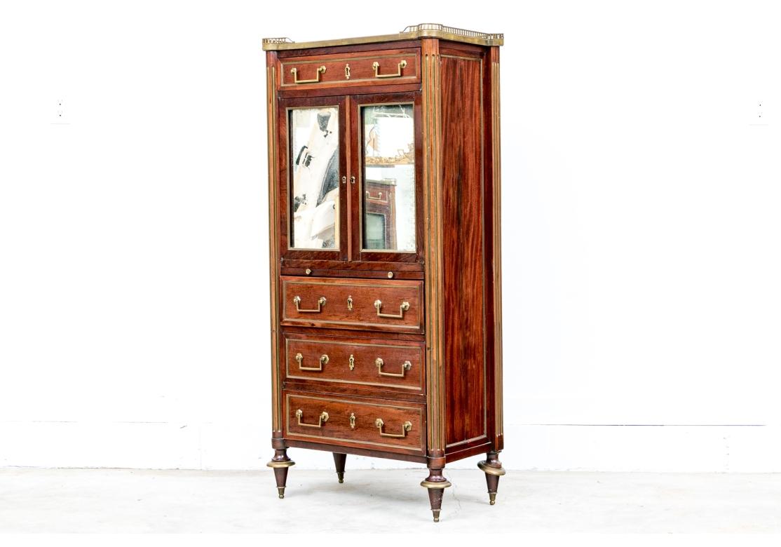 A finely constructed bookcase secretary with a chest. The tall cabinet has a pierced brass 3/4 gallery around the marble top with cookie corners. The bookcase has a frieze drawer over double mirrored doors opening to a single shelf. A green leather
