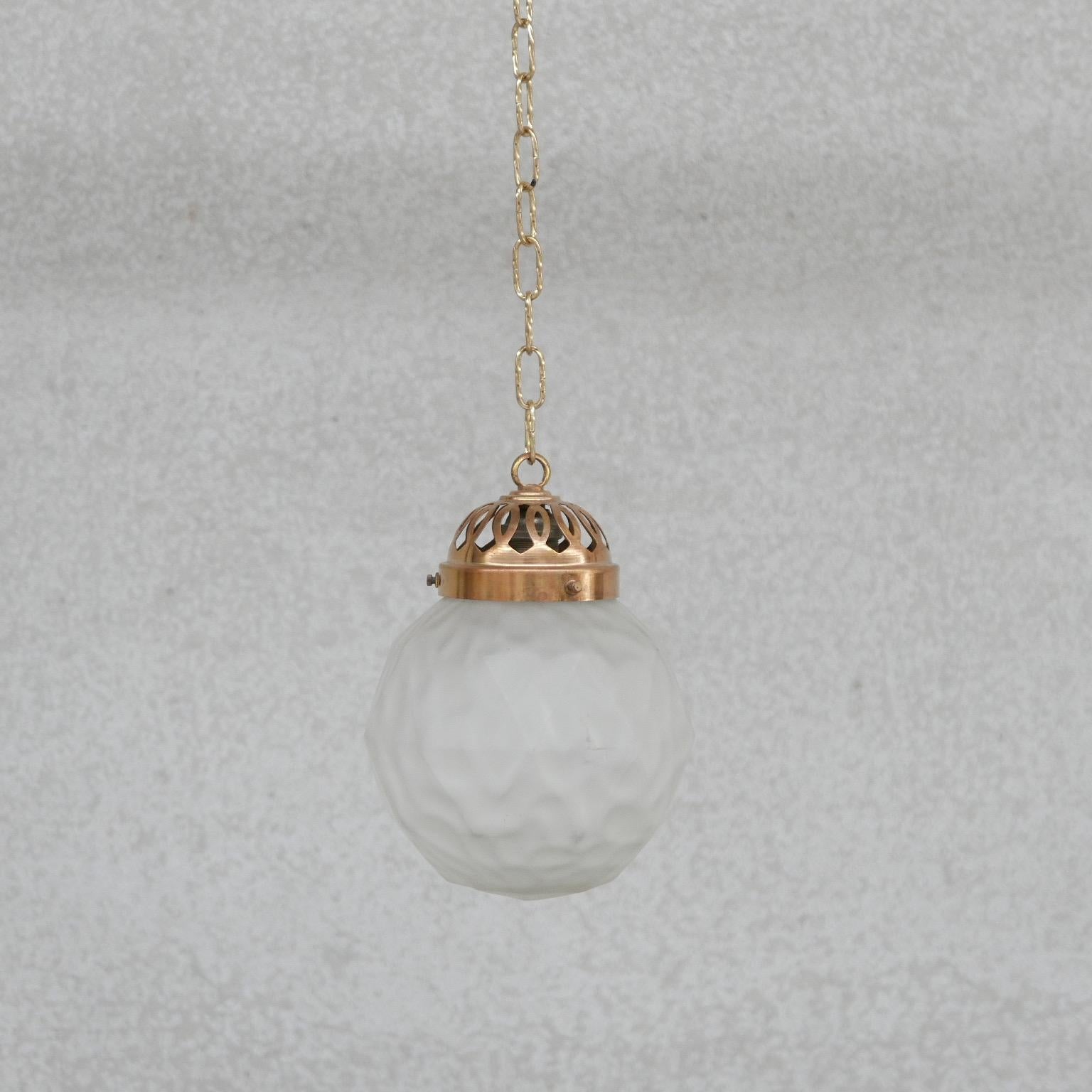 A small dinky French pendant light. 

France, c1930s. 

Decorative brass gallery with etched glass pendant. 

No chain retained, but we can provide upon request. 

Since re-wired and PAT tested. 

Do check dimensions - as it is small.