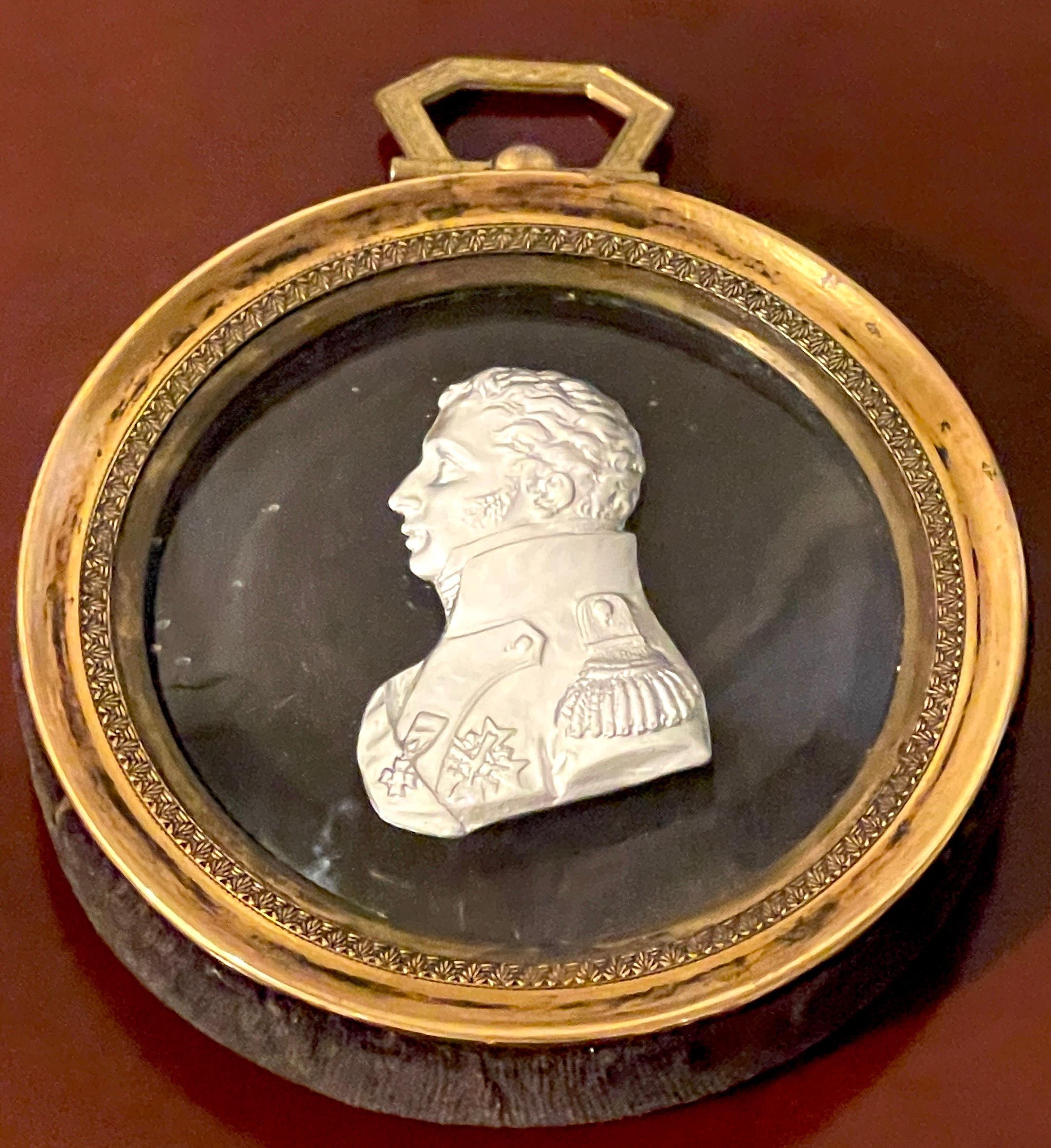 Diminutive brass framed sulphide portrait bust of Charles X
France, circa 1850s.

Of typical form the circular convex clear glass and white highly detailed side profile portrait of Charles X (1757-1836) in military dress, with numerous medals.