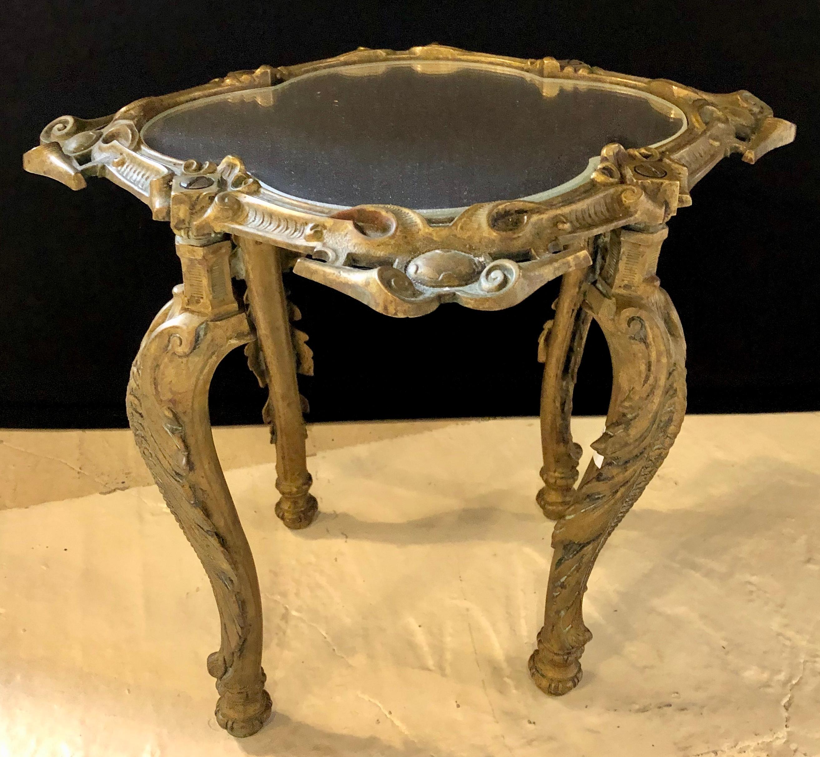 Diminutive bronze mounted coffee or end, side table. This sweet little rococo designed side or end table is simply stunning. The whole in a bronze frame with a mirrored table top.