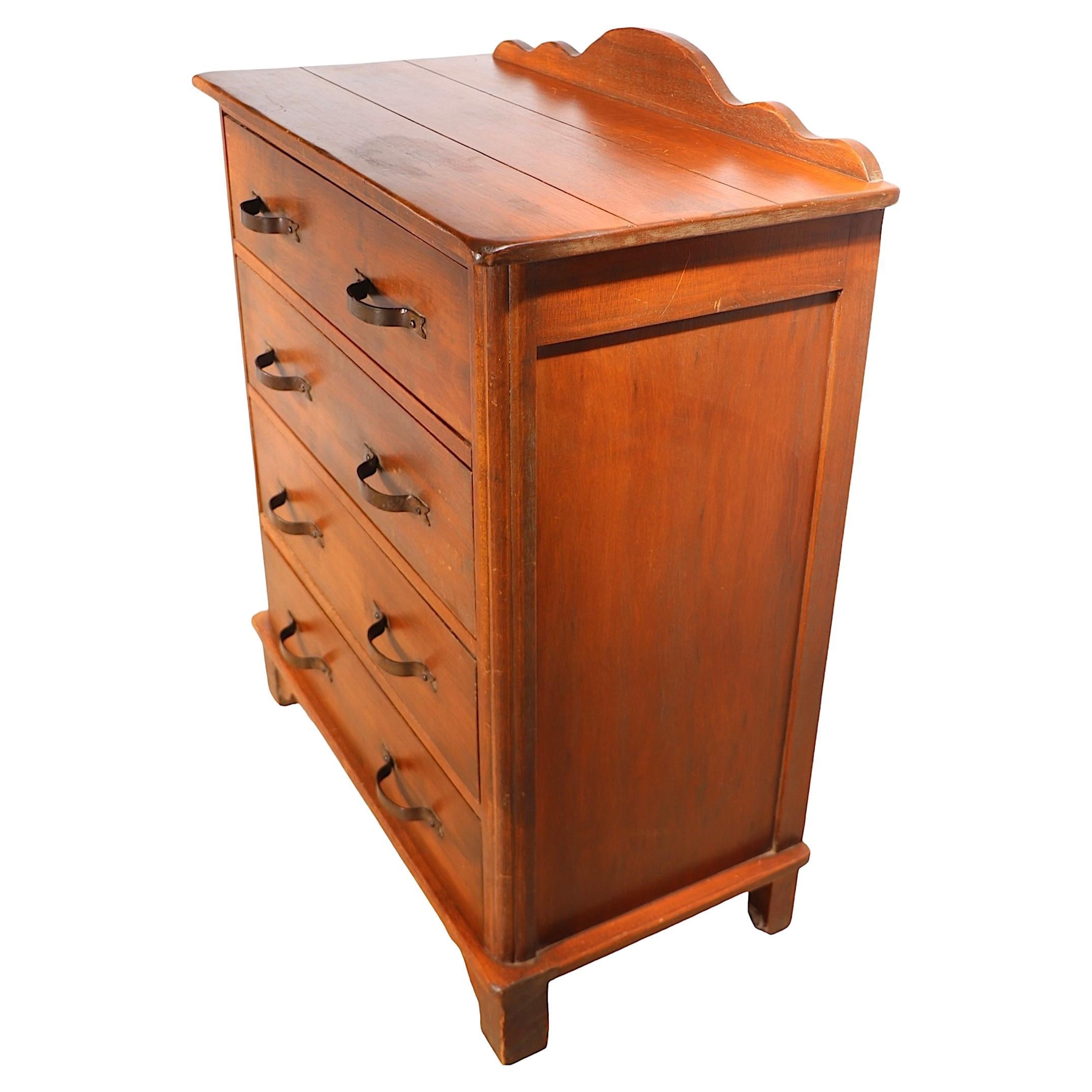 Comò rustico d'epoca della prima California prodotto dalla Monterey Furniture Company. La cassettiera è dotata di quattro cassetti con due maniglie in ferro battuto, il piano superiore è in legno.  ha un elegante backsplash sagomato. Probabilmente