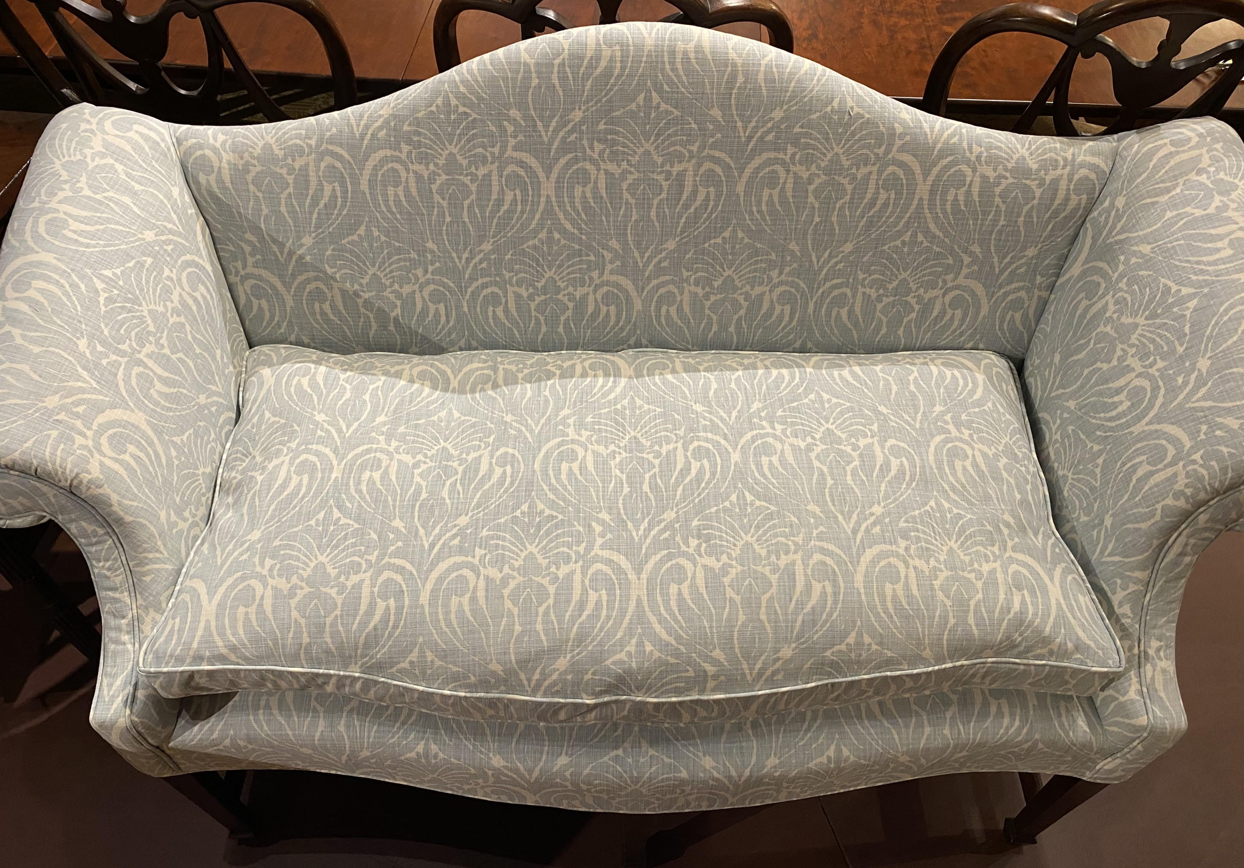 A fine diminutive Chippendale style mahogany camel back settee by Jeffrey Greene of Newport, RI, with mortise and tenon construction, scrolled arms, serpentine front rail , all supported with six legs, the front terminating with spade feet, and