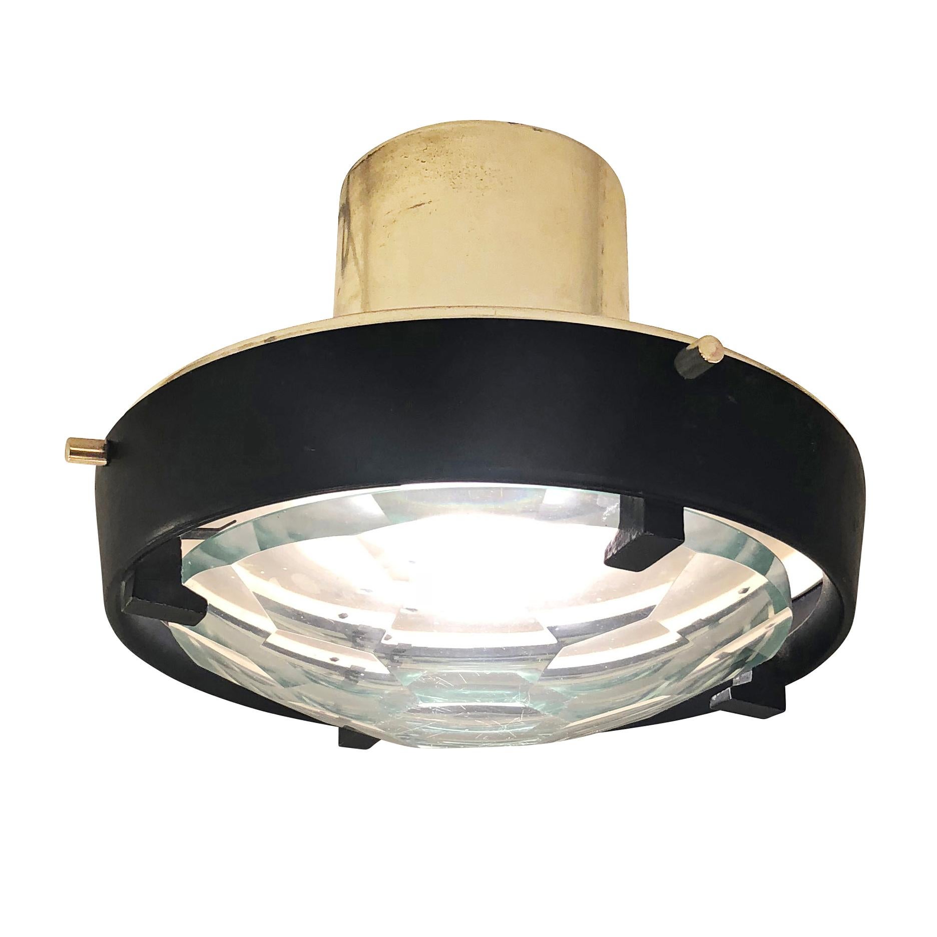 Small flush mount fixture attributed to Fontana Arte with a faceted glass. The frame is brass plated and lacquered black. Glass can be frosted on request to hide the light bulb. Holds one regular socket. Attribution based on recent auction