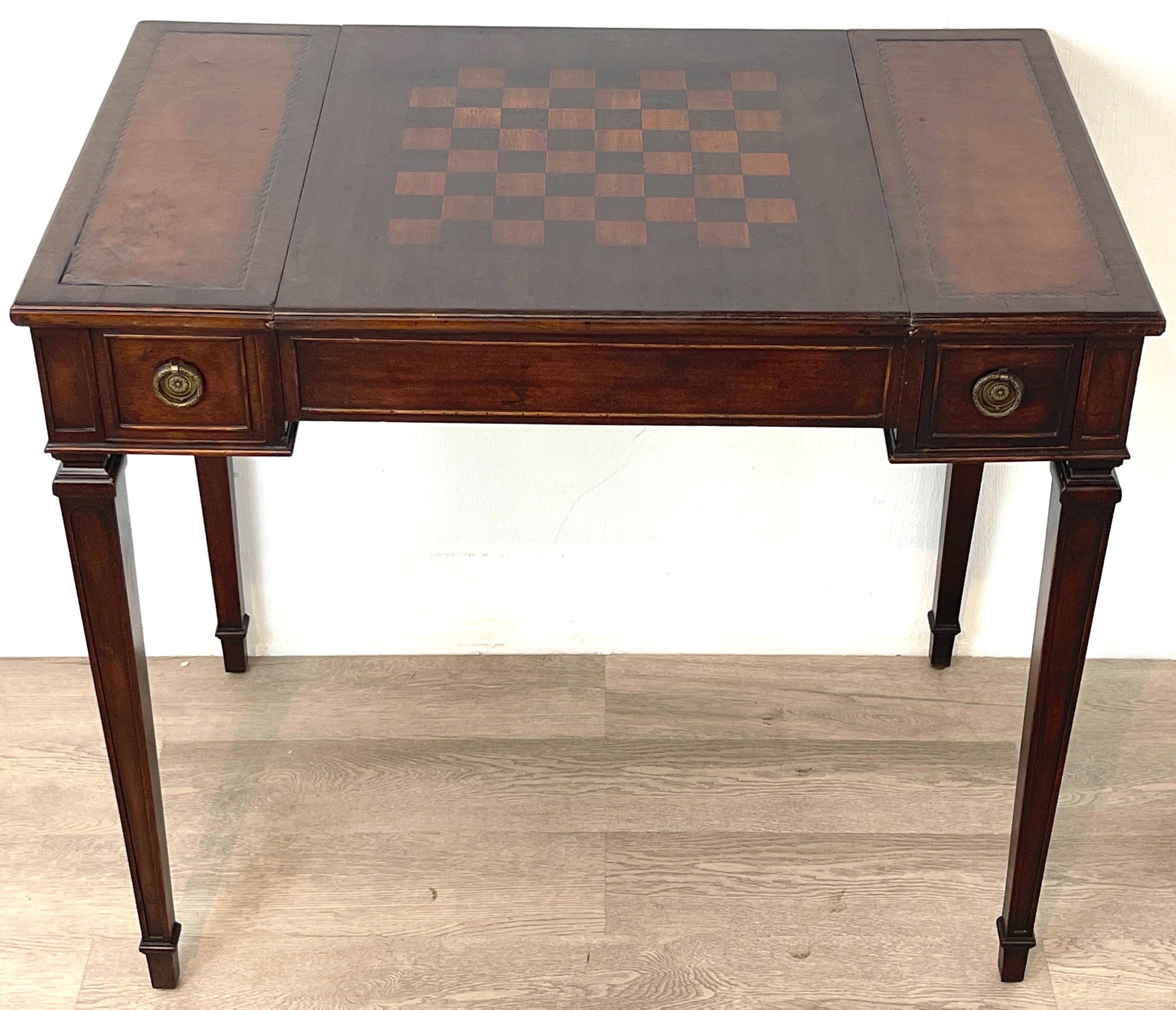 Diminutive French neoclassical inlaid mahogany games table 
France, Circa 1940s
A nice example, with all over intentionally 'distressed' finish. The rectangular top with a removable / reservable square top, with flanking inset brown leather