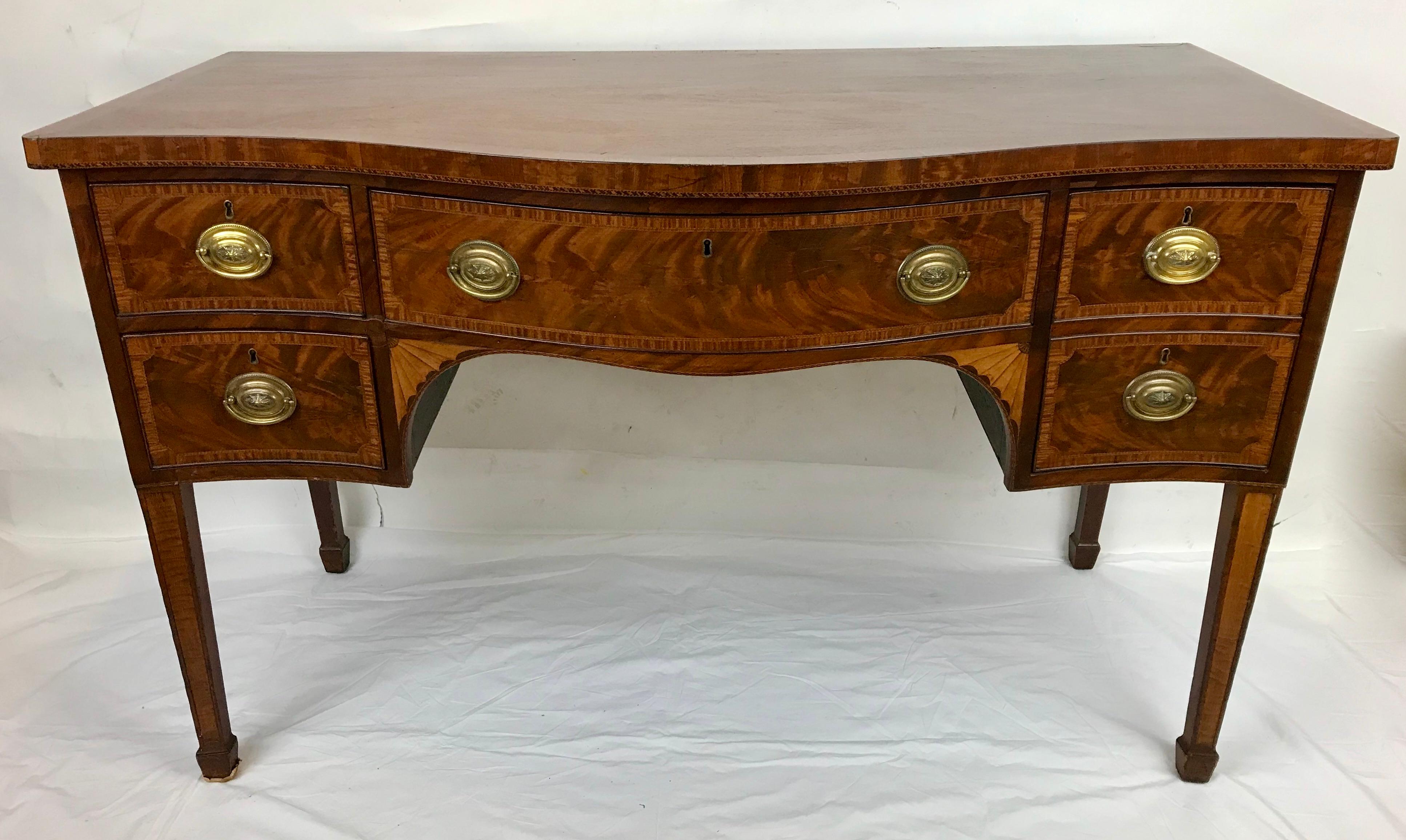 This Georgian serpentine sideboard features fine inlays, banding and cross banding. It is in wonderful condition, with beautifully colored flame mahogany panels, and a fine old finish.