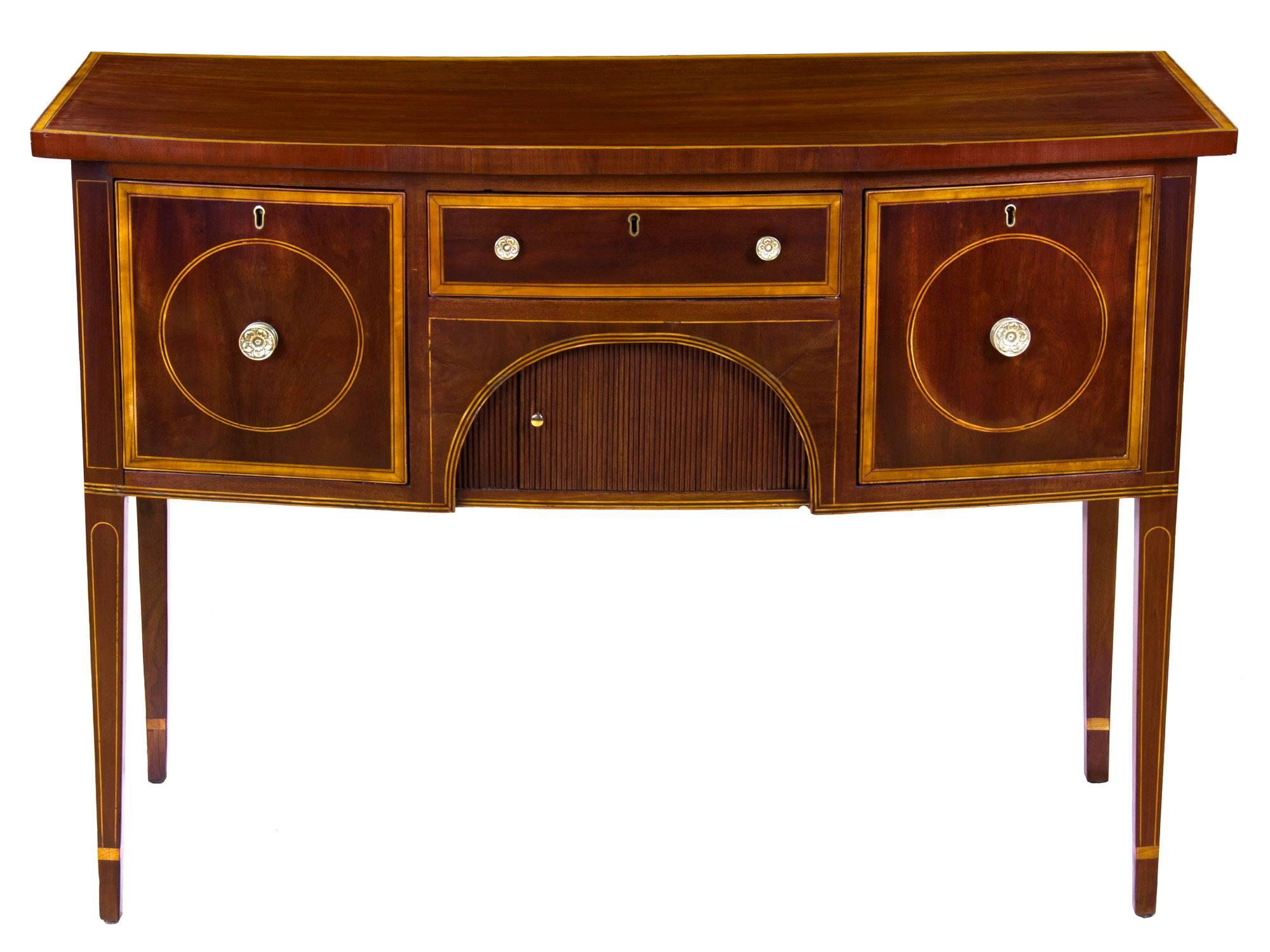 This server or sideboard is of a highly desirable small size. The top has a beautiful satinwood edge banding, which is further accented with ebony. The drawers are also of a beautifully figured mahogany which is embellished with ebony line inlay and