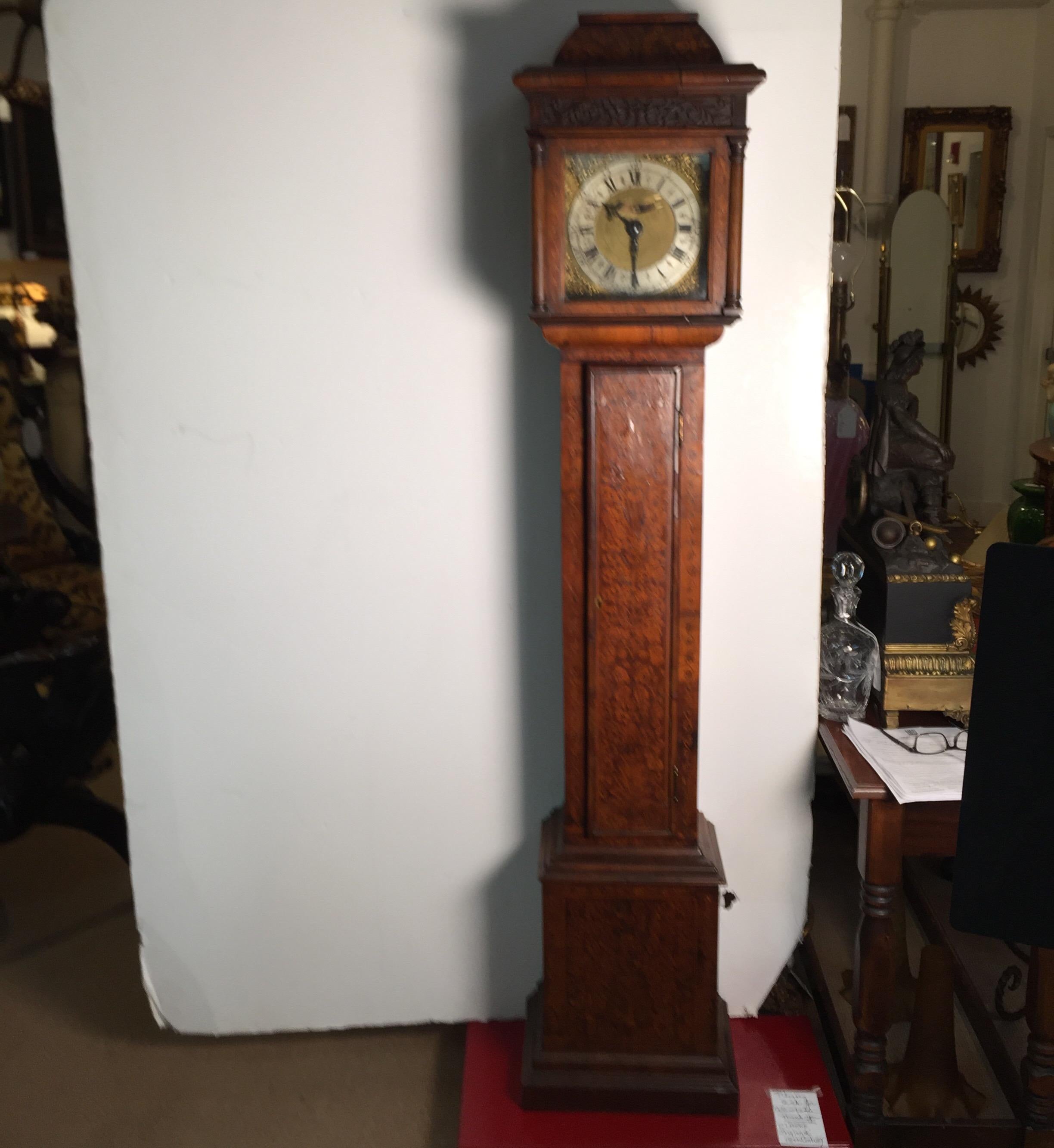 Antique inlaid grandmother clock, England early 1800s with works made by G. Clarke of London, 1740. The weight driven 30 hour movement with 8 bell strikes. 70 inches tall. Clocks may need servicing after shipment.