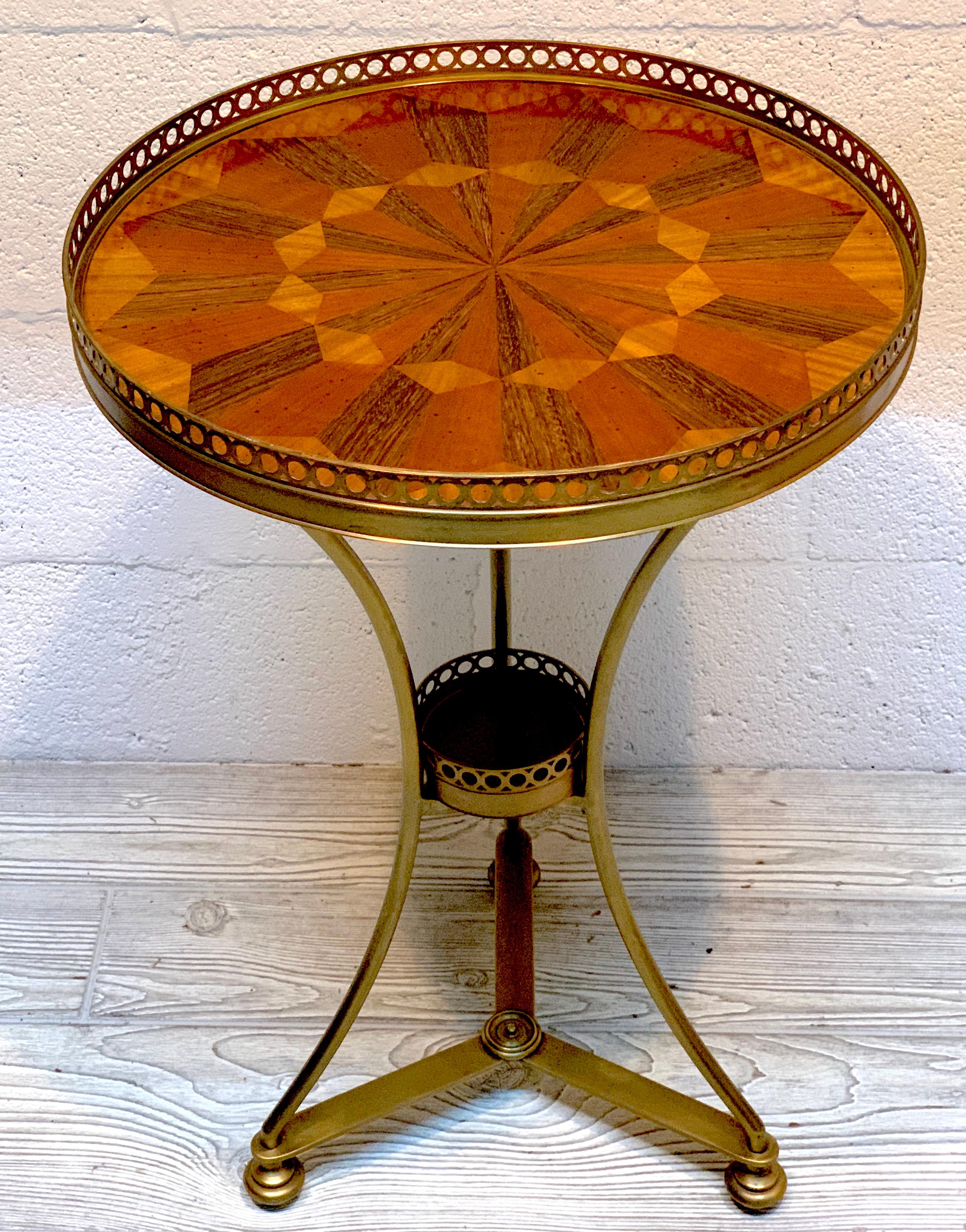 Diminutive Italian bronze and marquetry gueridon, of circular form, with pierced gallery surround the exotic wood marquetry top, raised on a tripartite base with 4
