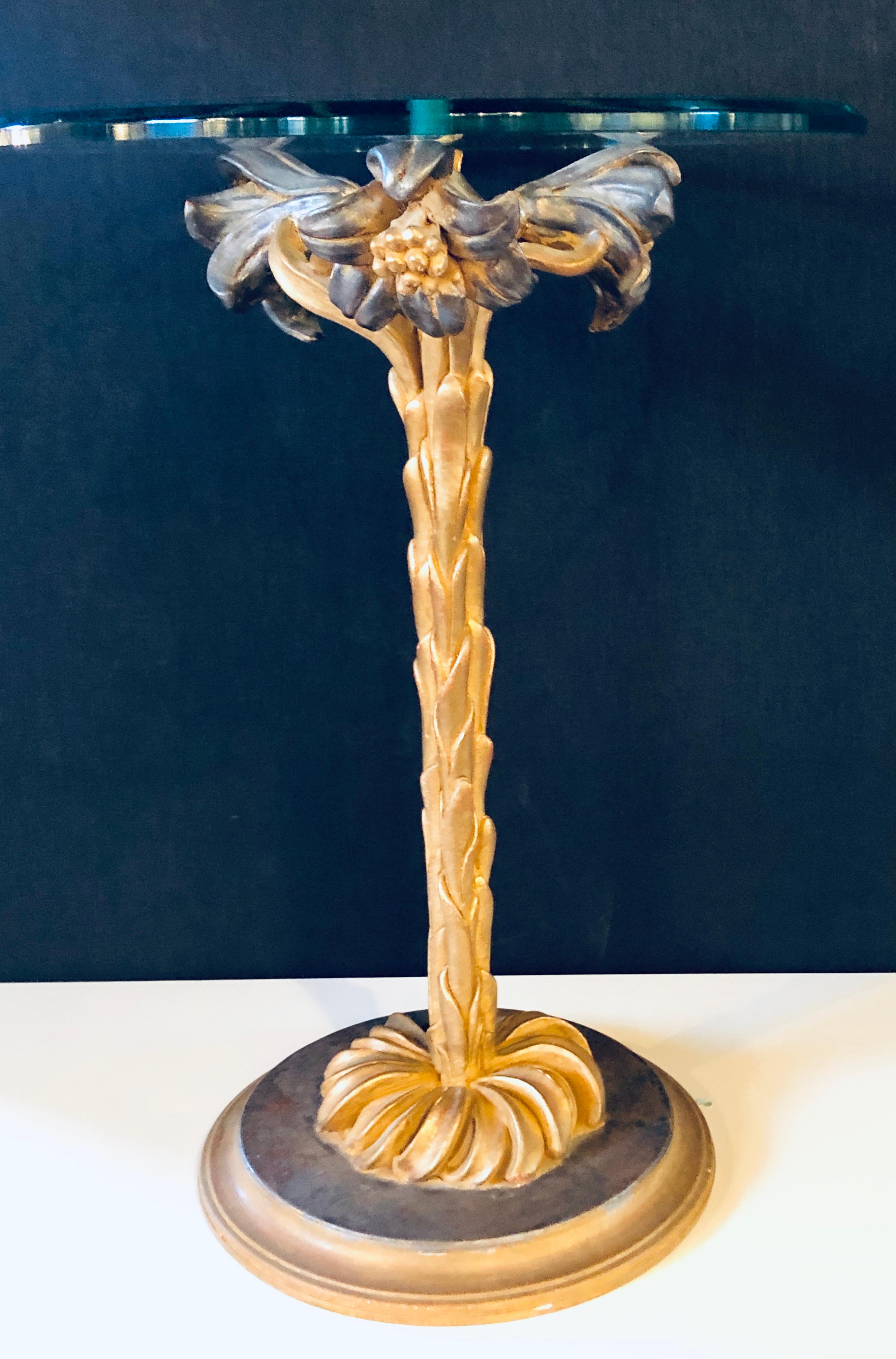 Diminutive Italian glass top palm tree form end or side table. This nicely carved and paint decorated side or end table is simply stunning and very sweet. The thick glass top supported by a palm tree base of gilt form having grapes flowers with a