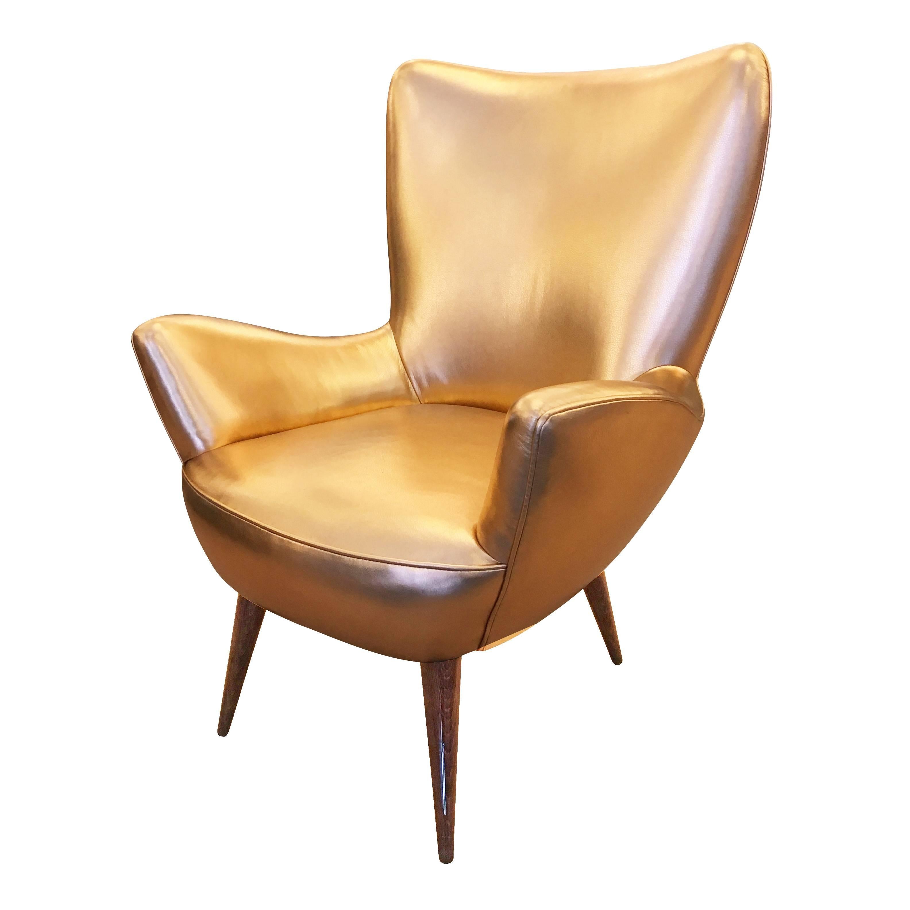 Charming Italian Mid-Century lounge chair with soft and well designed silhouettes. The legs are wood. Was upholstered in a metallic gold leather for the 2018 Kips Bay Show House in NYC.

Width: 27.5
