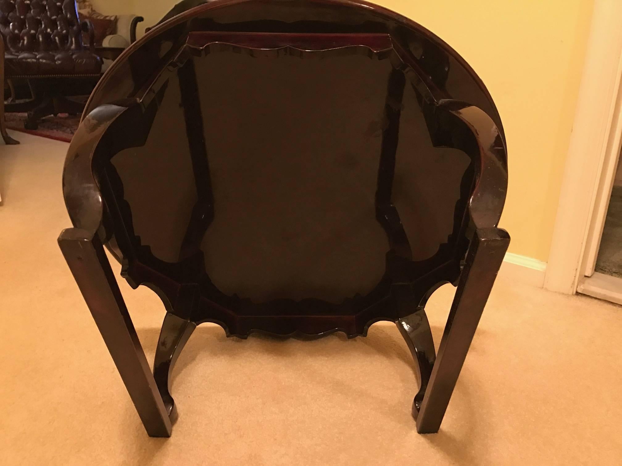A diminutive Korean wood and lacquer soban tray table. The round top with scalloped apron resting on four tusk shaped legs. The finish is a glossy lacquer with a deep rich brown java stain. This table would work a display Stand or bed tray. Soban