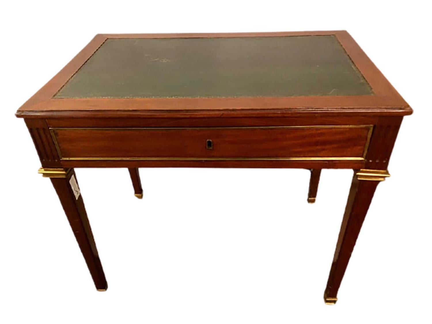 An early Louis XVI style leather top desk with pull-out sides and bronze mounts with a single centre drawer stamped Jansen. Pull outs measure 15.5 x 9 inches each.