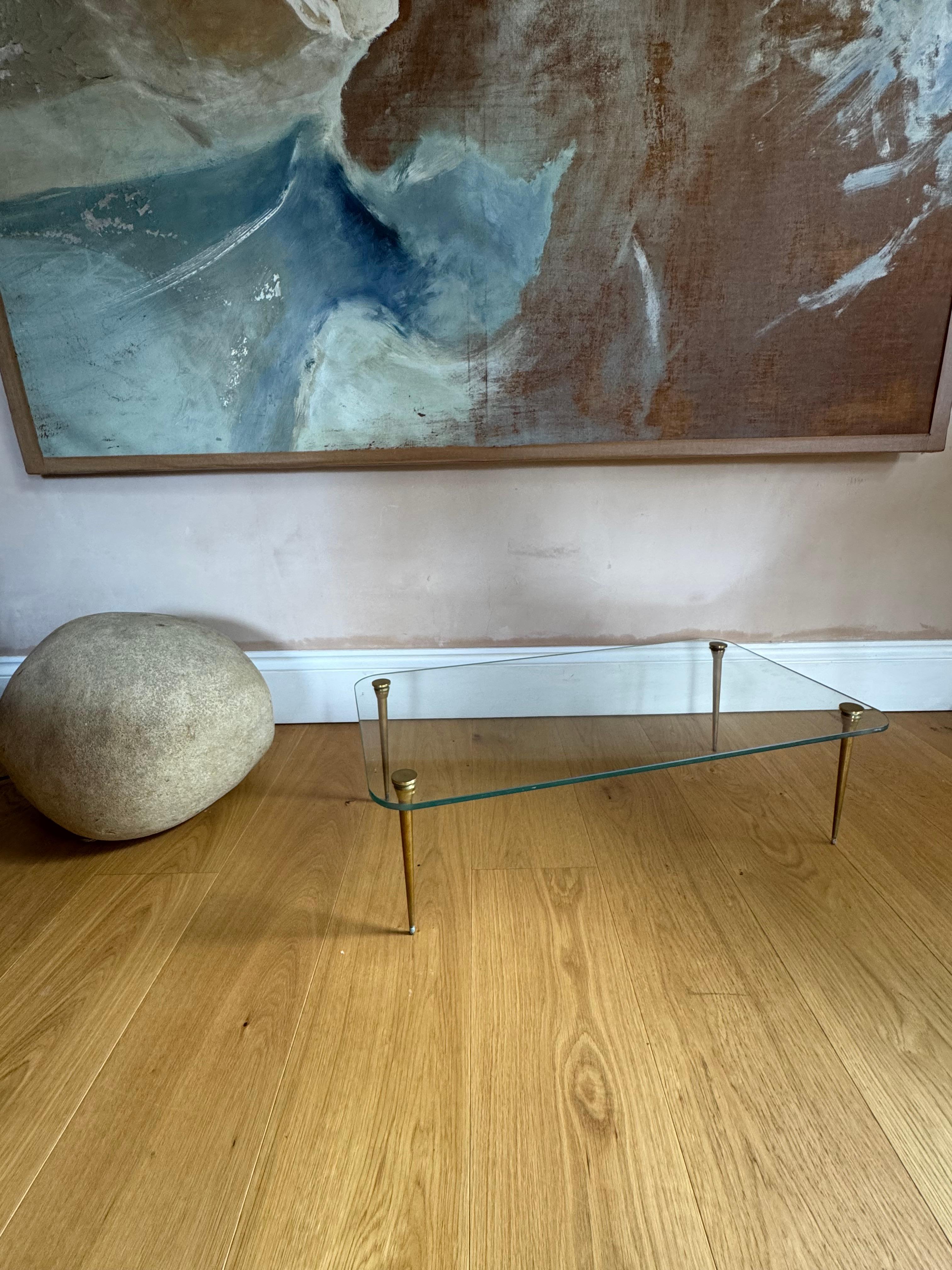 A very sweet and elegant Saint Gobain glass topped low and small coffee table with solid gilt metal legs. 