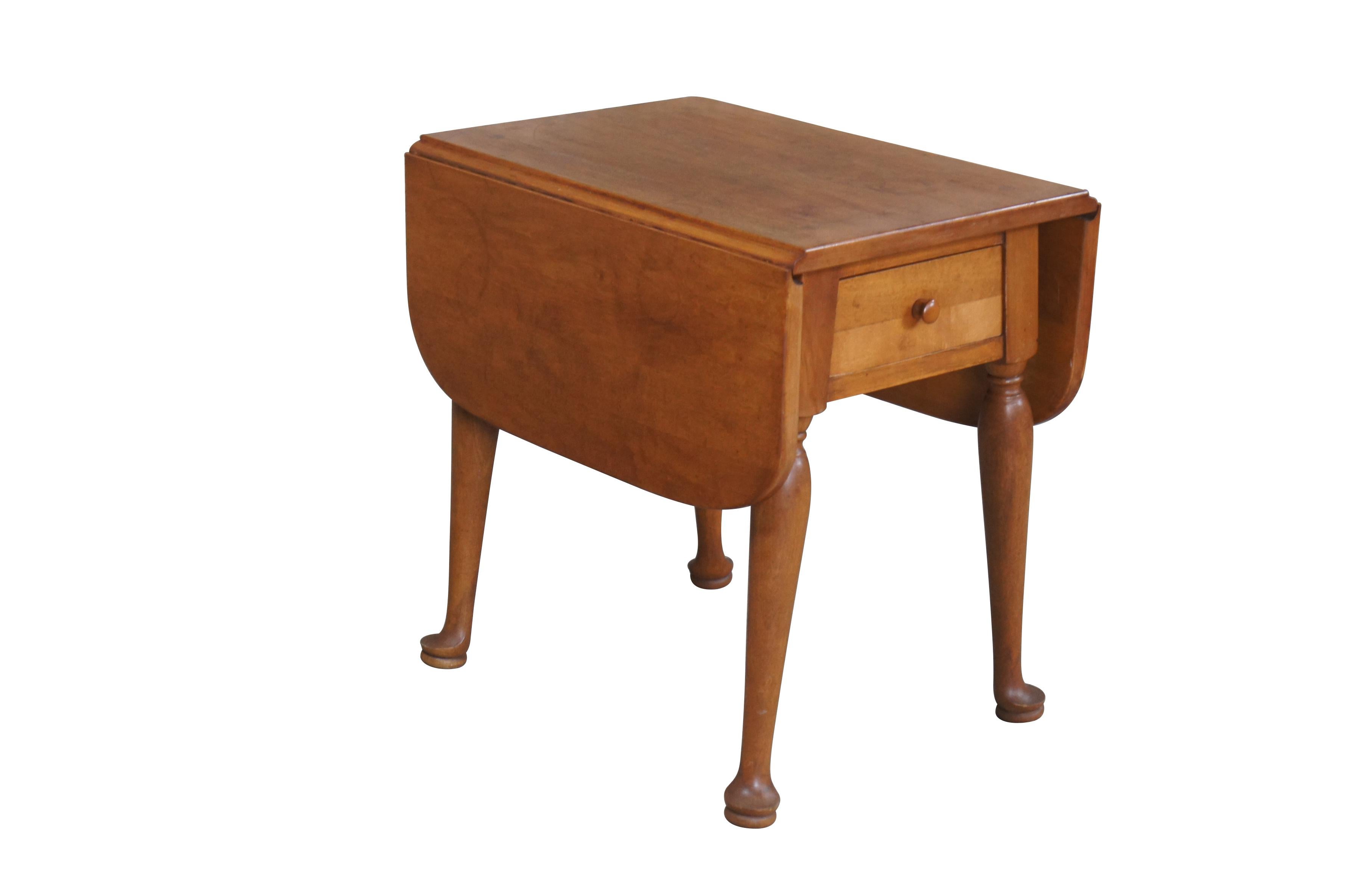 A quaint side table by W.F. Whitney Company, circa mid 20th century.  Features 18th century Early American / William & Mary styling with a central drawer over turned legs leading to pad feet. Marked 3505 long underside.  

W.F. Whitney manufactured