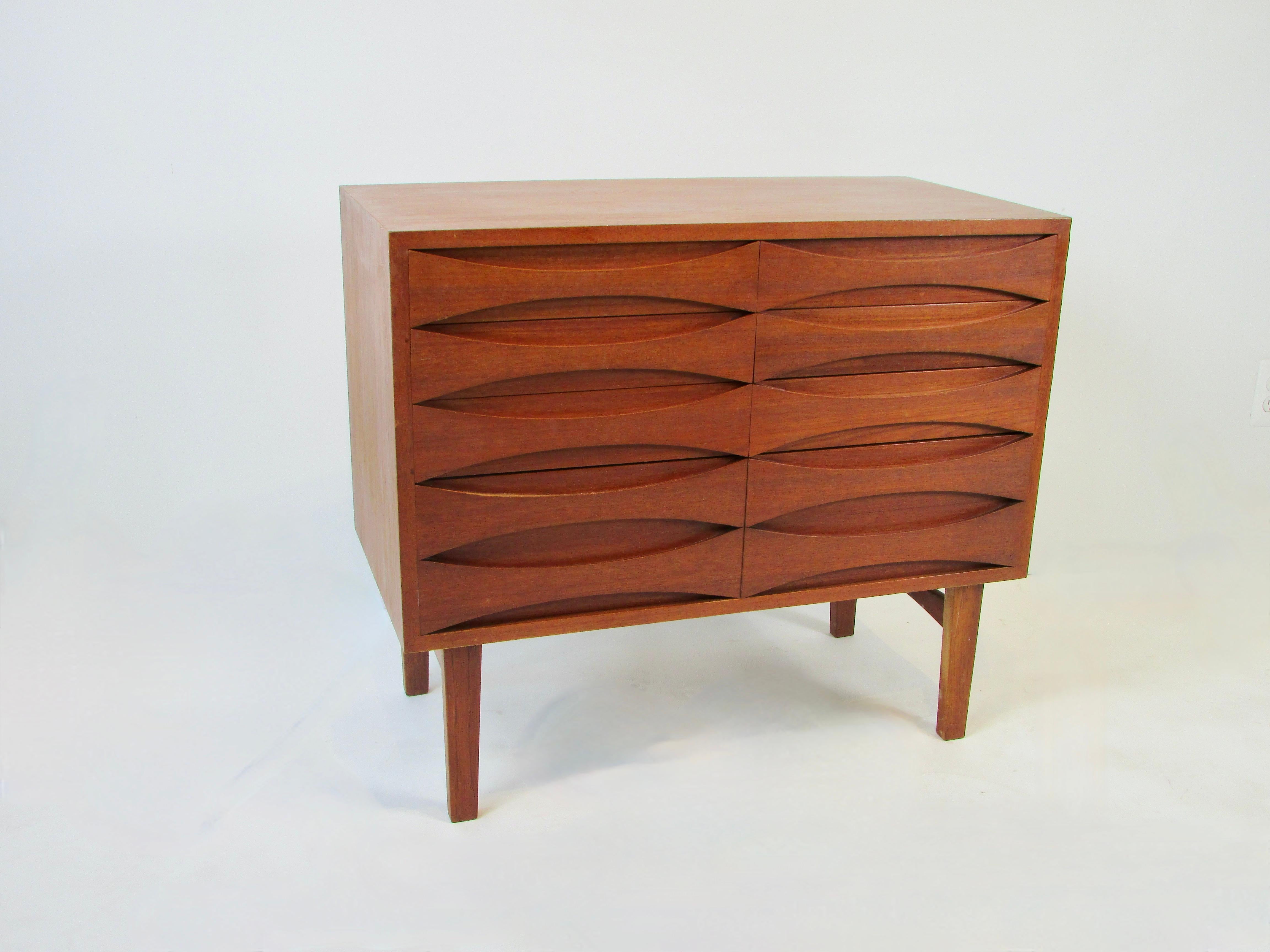 Nicely made Danish teak eight drawer chest Designed by Niels Clausen manufactured by Niels Clausen. Scalloped front drawers are of dove tail construction front and back. Hard to find smaller size cabinet.