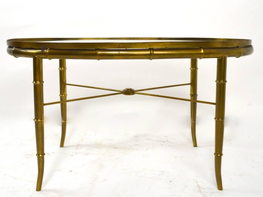 Oval brass faux bamboo base with plate glass insert top made by Mastercraft. Excellent, clean, original condition, ready to use.