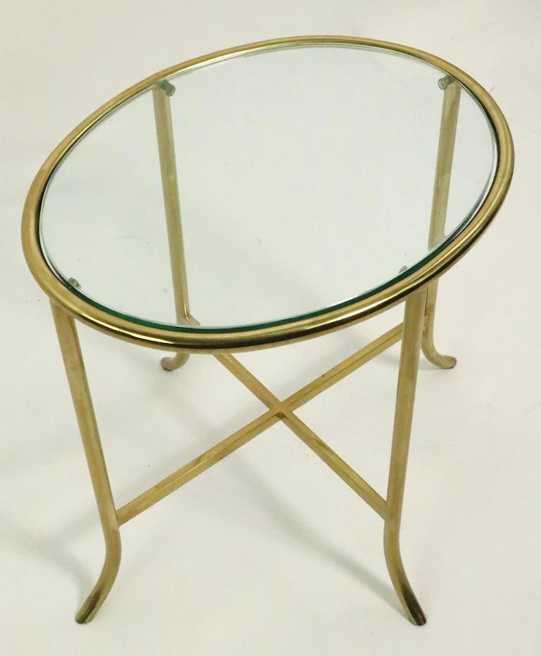 Well crafted brass side table with original plate glass top. Constructed in the manner of Cedric Hartman pieces, possibly Hartman, or Mastercraft manufacture. Clean and ready to use condition.
