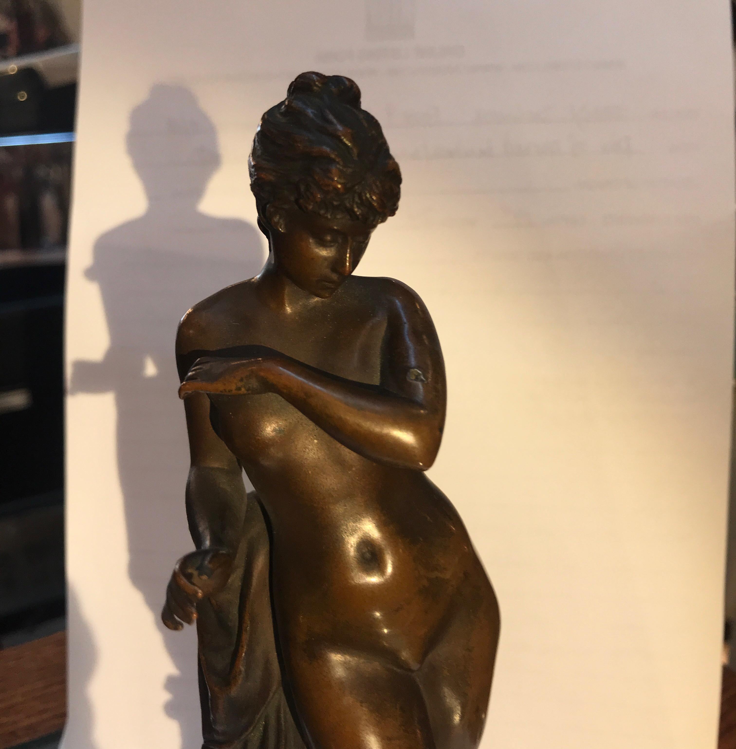 A 9.5 inch beautifully cast 19th century patinated bronze with round marble plinth base. The figure of a young woman posed with a draped robe along side of her, artist signed F. Groling and foundry mark of Gladenbeck. 
Carl Gustav Hermann