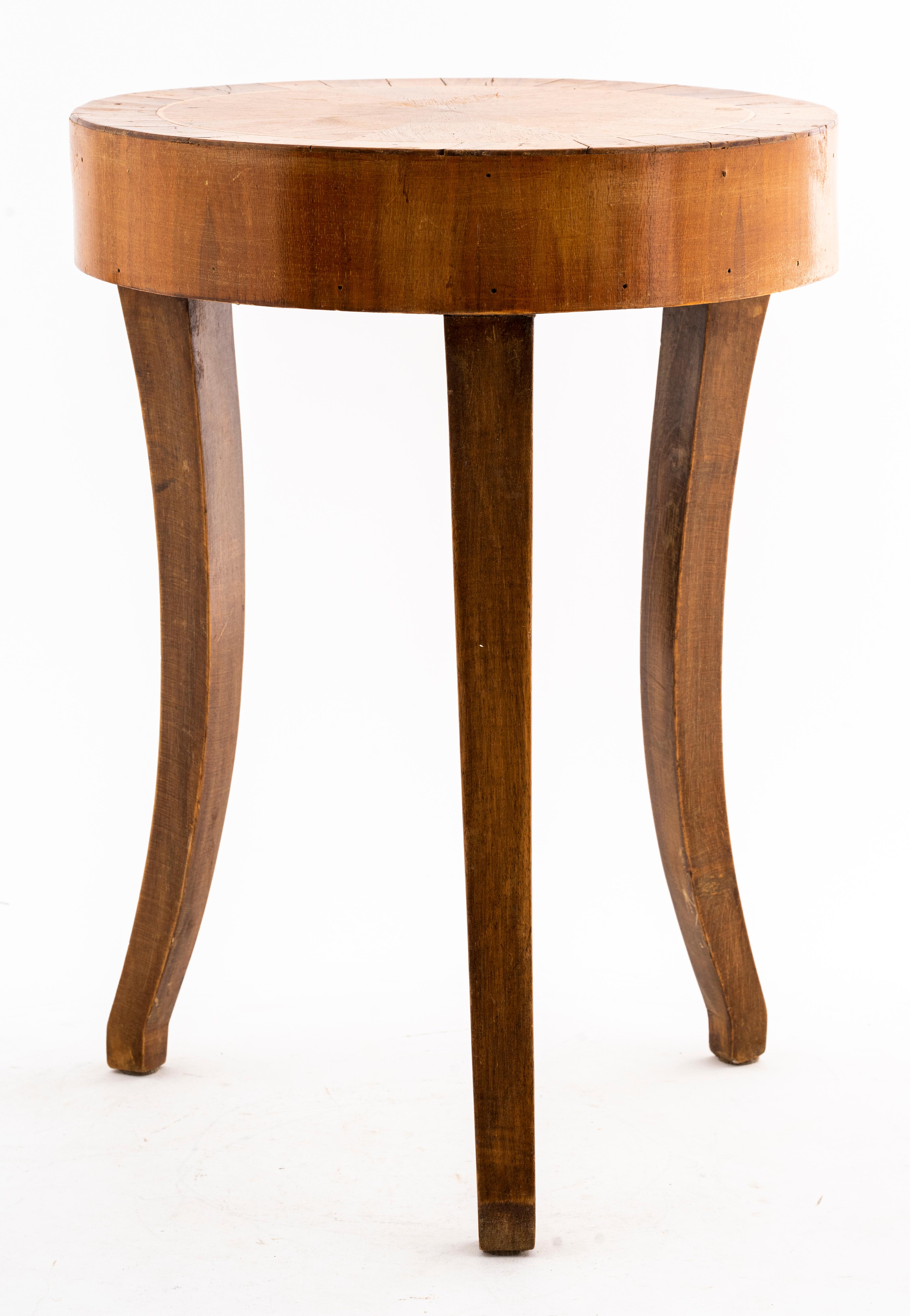 Diminutive round side table with inlay top and three legs. 
Dimensions: 17