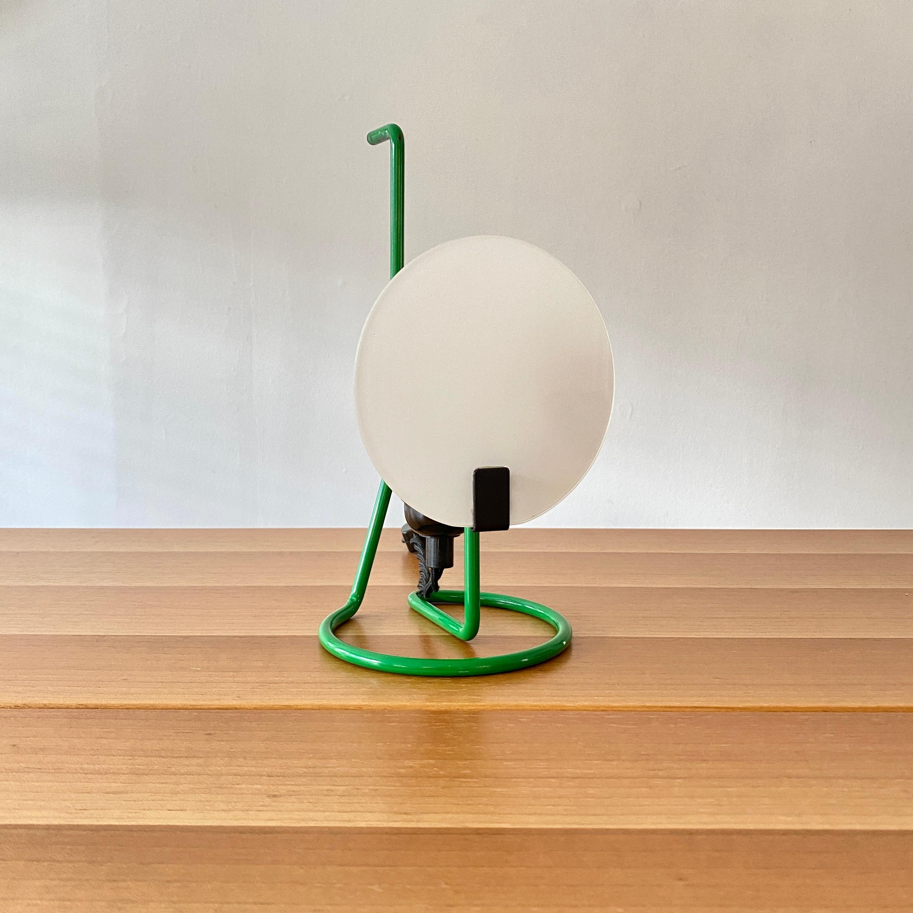 An uncommon diminutive table or accent lamp from Stilnovo. The lamp has a bright green handle / body with an opaque diffuser, the bulb socket is plastic with a 13 foot nylon twist cord, a two stage off / on switch and a vintage inspired plug. The