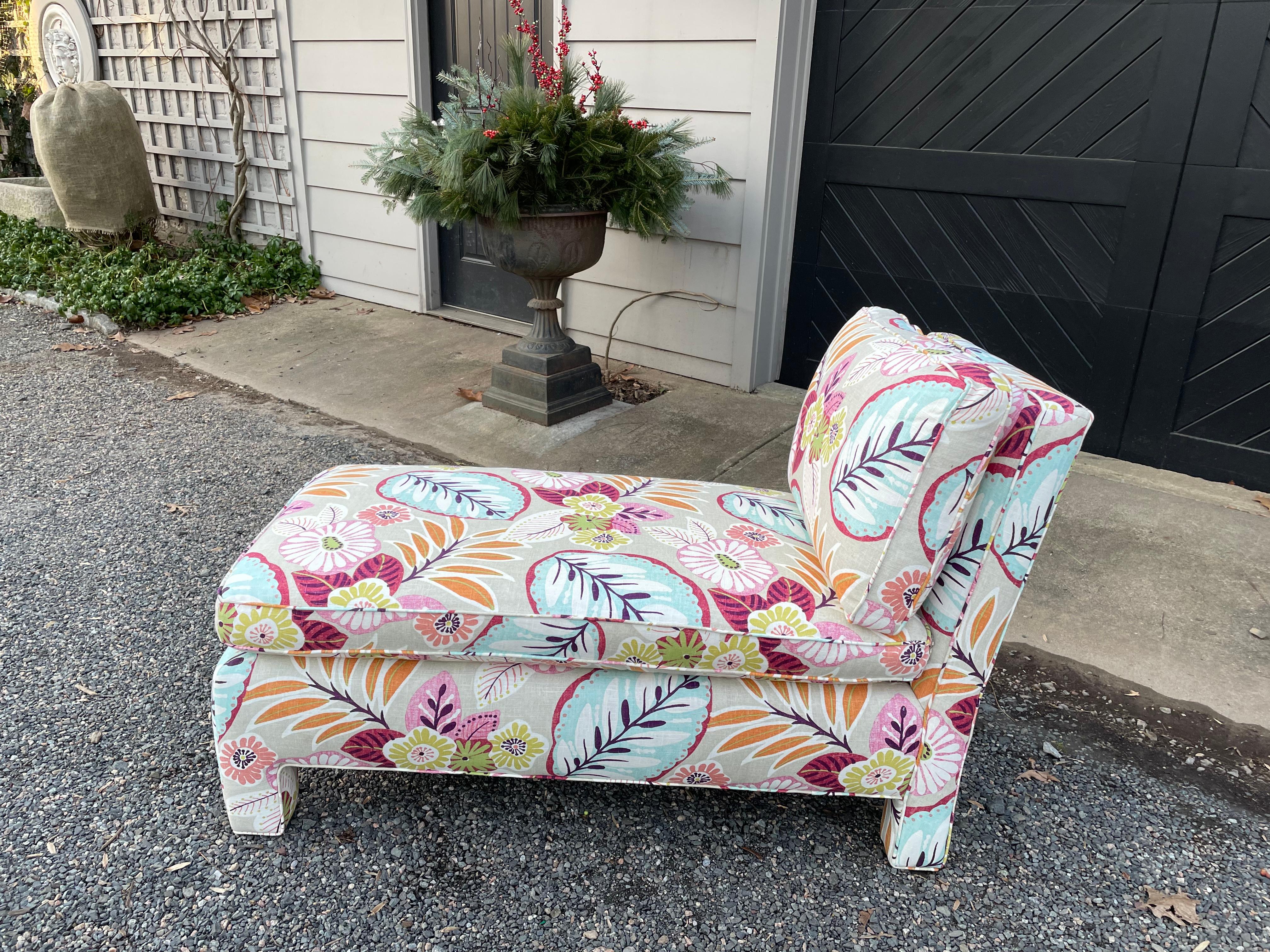 Super stylish updated mid century modern chaise lounge upholstered in a smashing contemporary floral linen having taupe background and wonderful palette of turquoise, pink, rasberry, lime green and orange.