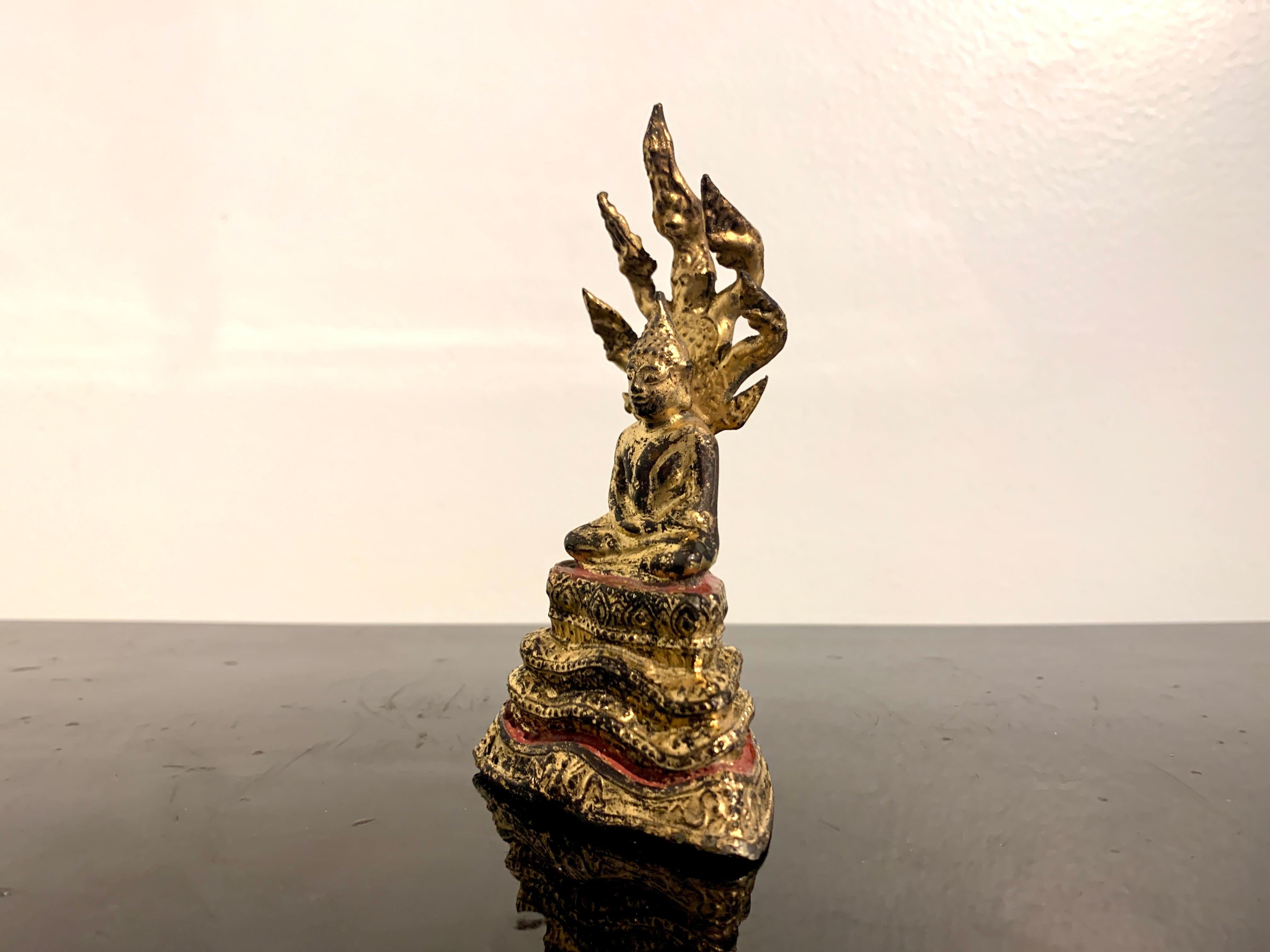 Cast Diminutive Thai Rattanakosin Gilt Bronze Buddha and Naga, 19th Century, Thailand
