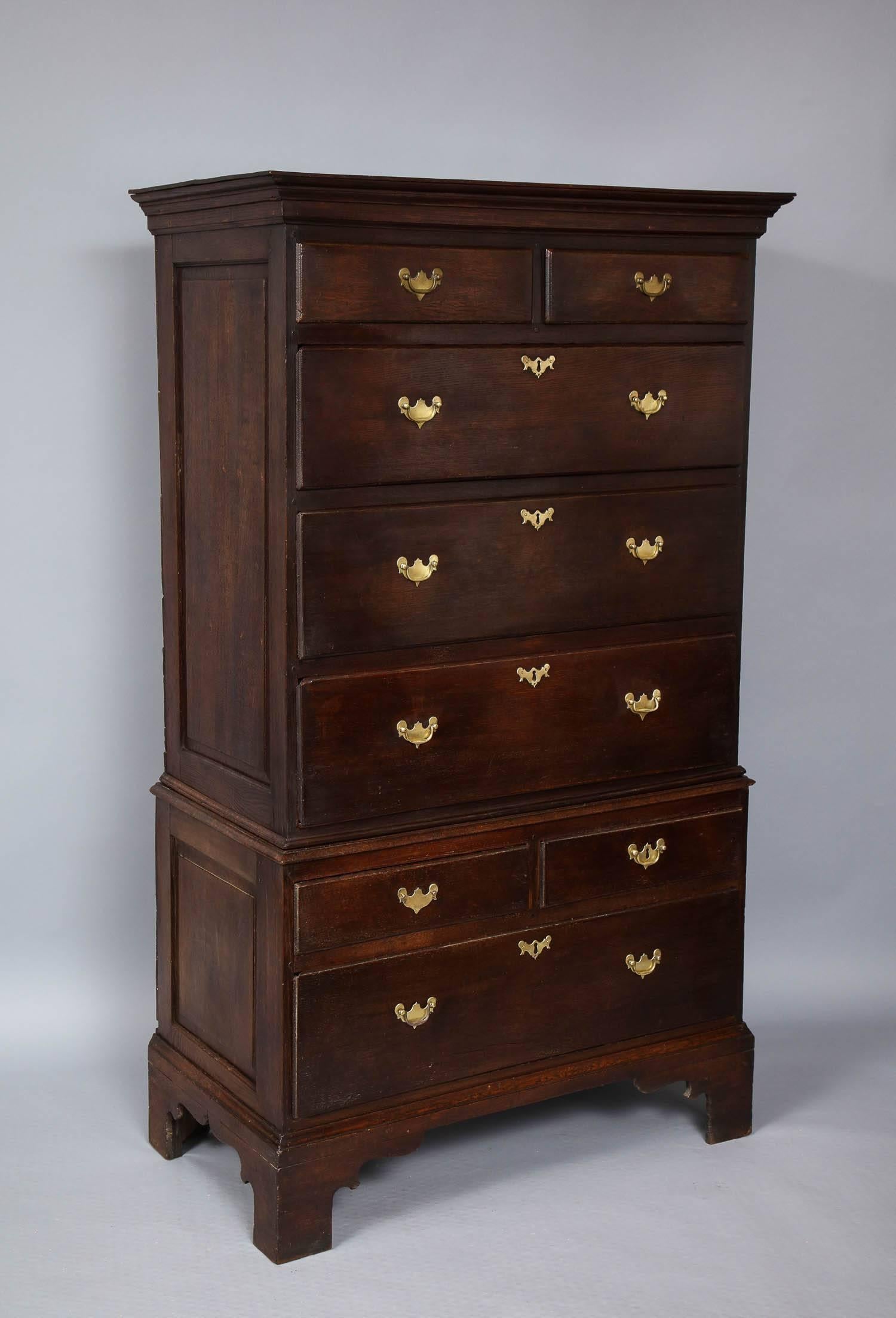 Fine 18th century Welsh oak chest on chest of diminutive scale, the top with flat and finished surface over two small and three large drawers, the lower section comprising two small and one deep drawer, the sides of both sections having paneled