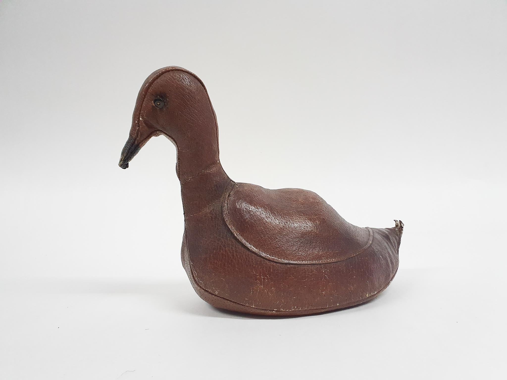 Leather duck stuffed with straw by Dimitri Omersa. The duck can be used as a door stop or as a decorative item in a kids room.
It has traces of use.