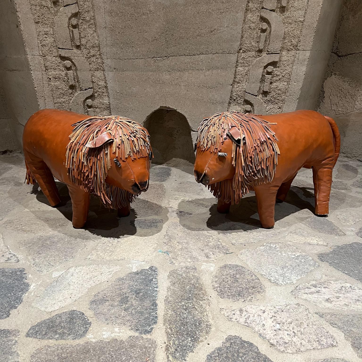 Two Foot stools
Pair of Leather Lion Foot Stools 
In the style of Dimitri Omersa for Abercrombie & Fitch.
No label present 
17 h x 27 long x 10.5 w
Preowned original vintage good condition. 
Tail has a prior repair.
See images provided.
Delivery to