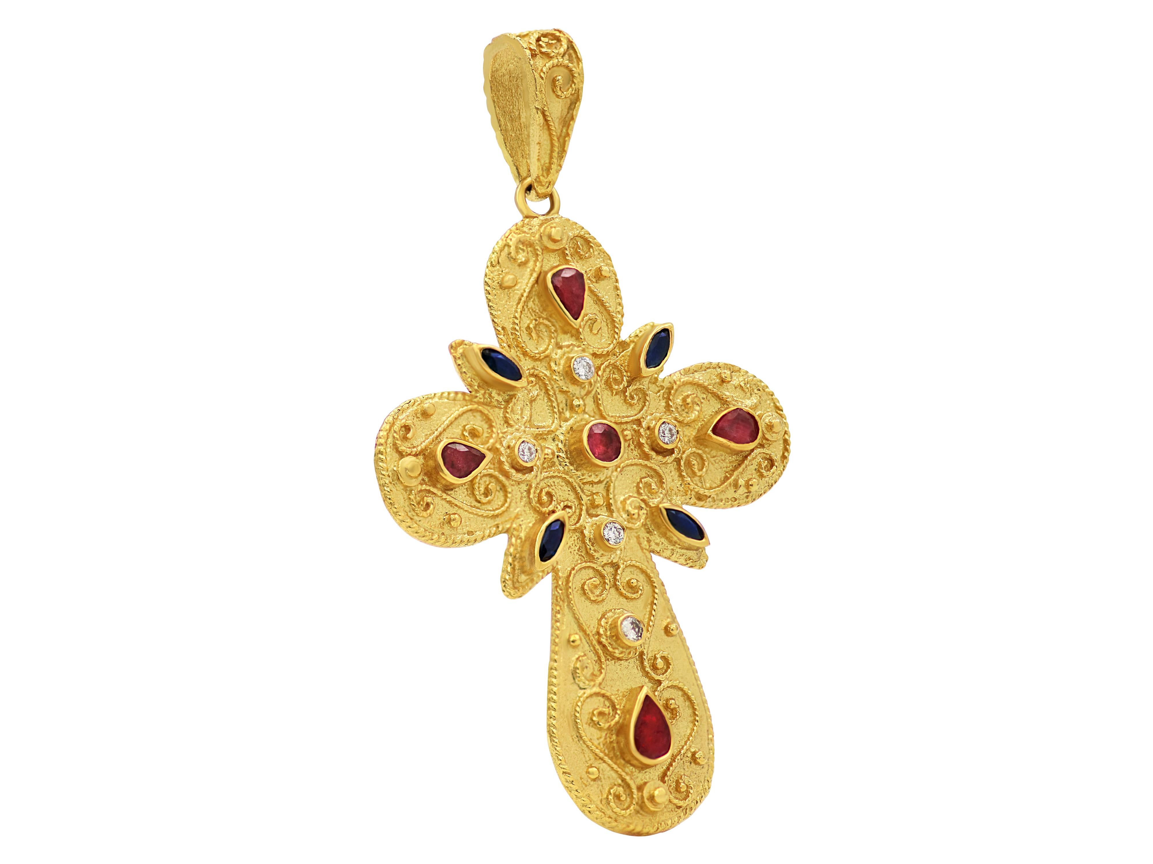 Byzantine cross in 18 karat yellow gold with a dynamic size. A variety of natural gems giving the authentic multicolor look of the Byzantine era. Artwork with filigrees and granulation complete this cross.