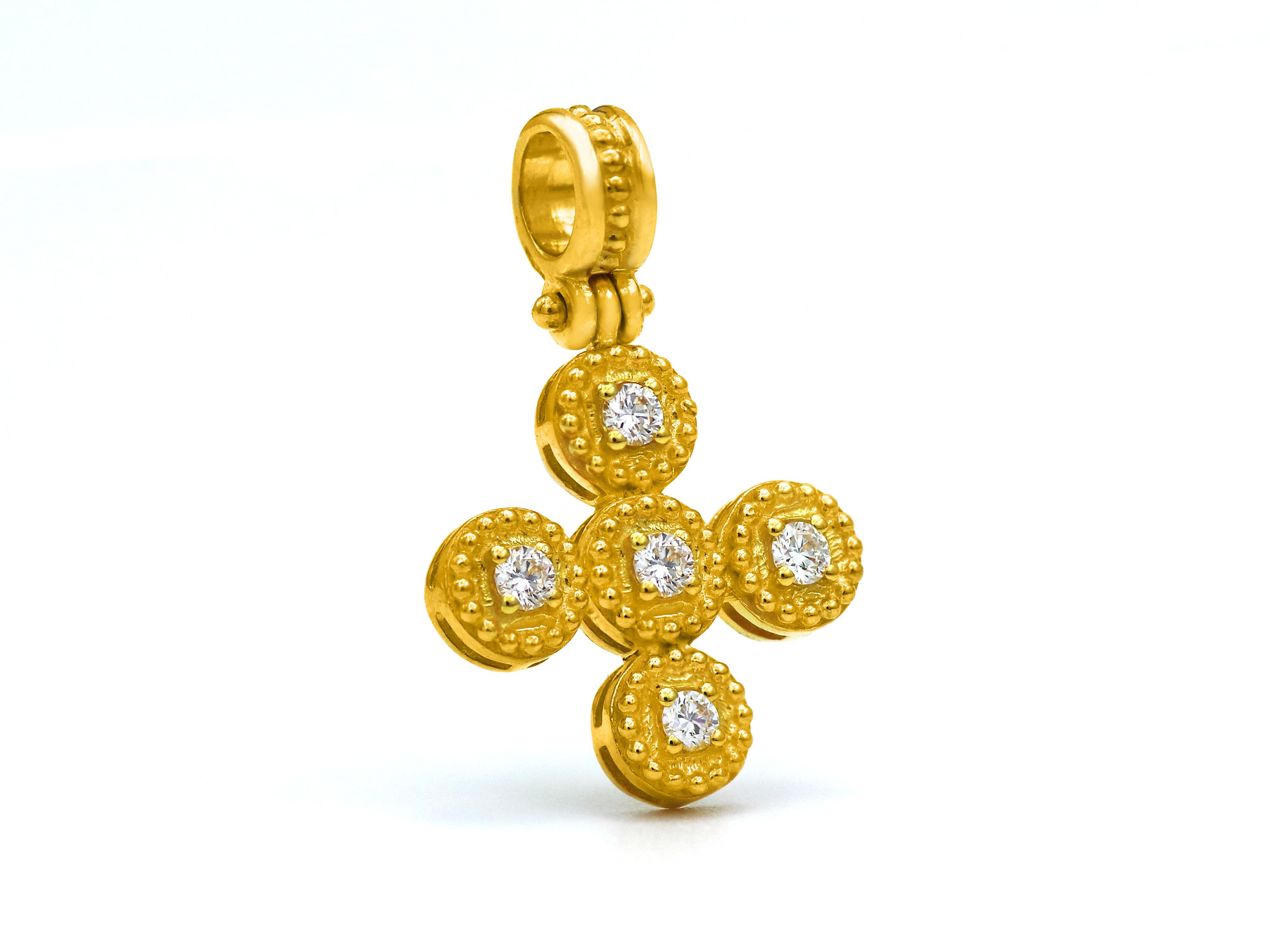 18k yellow gold cross of the balance collection with neoclassical inspiration work of granulations and a beautiful setting of four 0.20 carats not graded brilliant cut diamonds. A very tasteful piece with a strong thick bezel that will make you wear