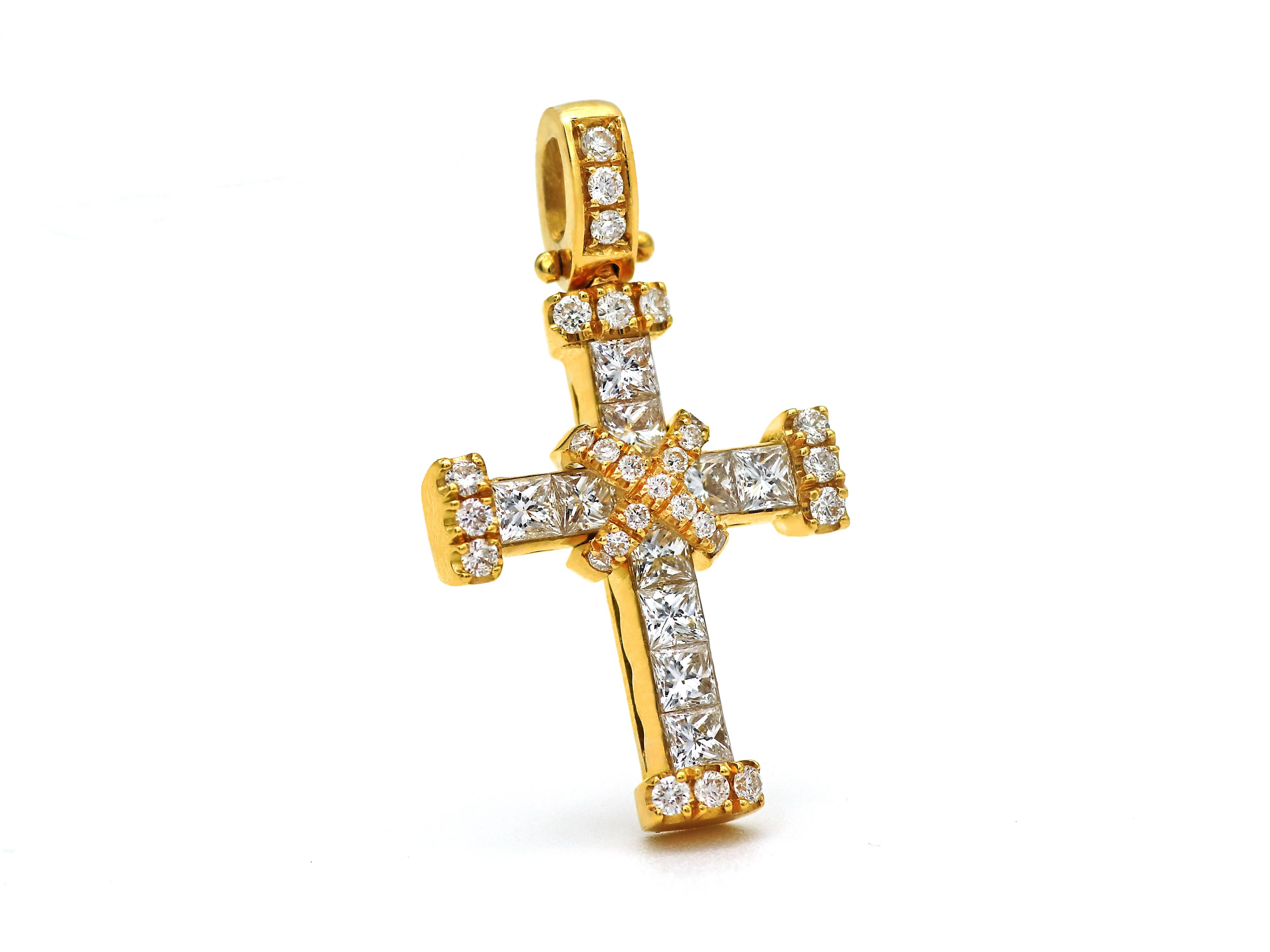 Diamond cross in 18 karat yellow gold in a nice solid and heavy construction with invisible sets of 1.50 carats princess cut diamonds and brilliant cut diamonds on each side and center.
Invisible setting is one of the most difficult ways to set