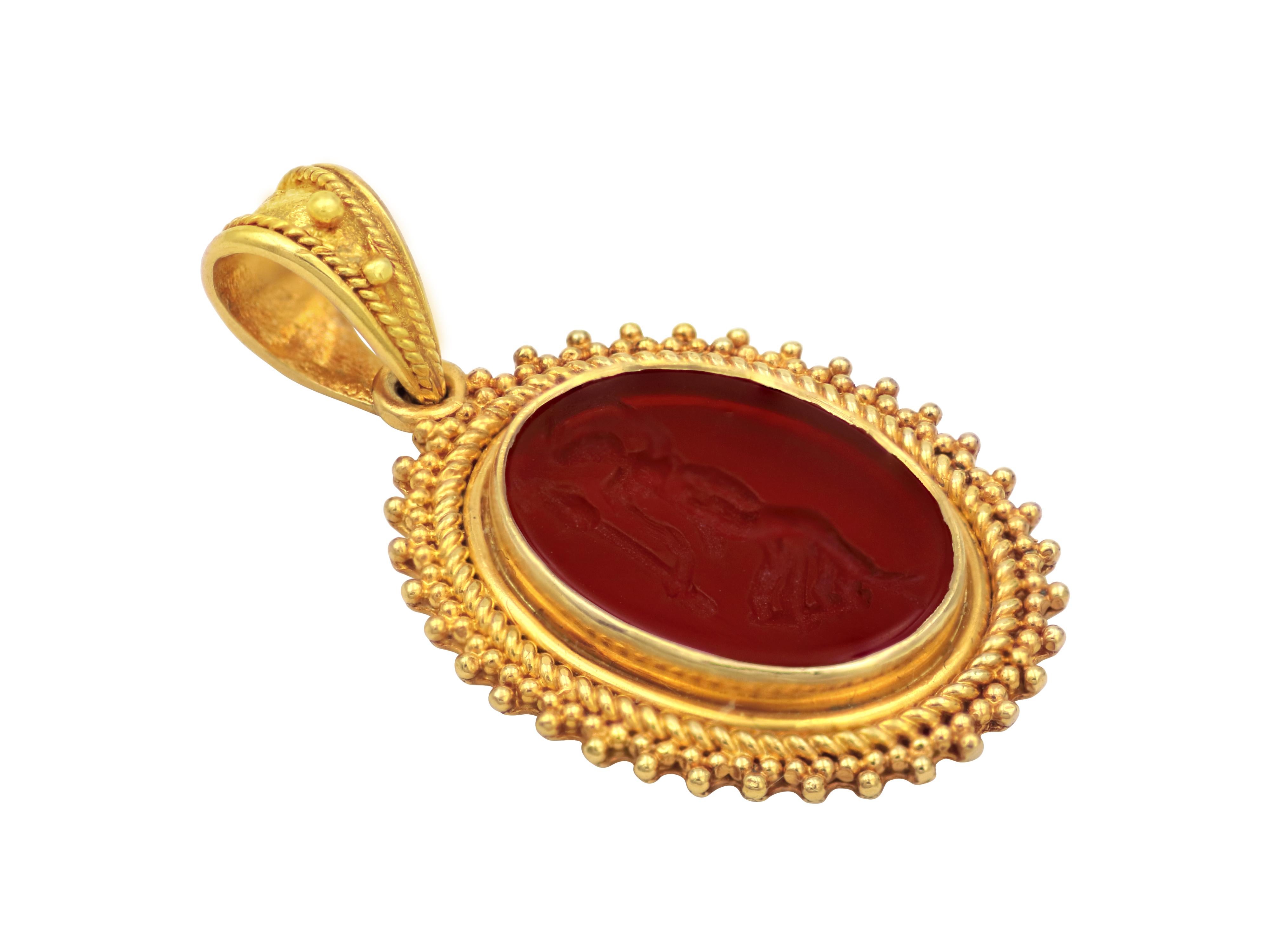 Cornelian pendant carved with goddess Nike. The winged goddess of victory. Check out the incredible detail of filigrees and granulation creating a depth in a 3-D look on this one-of-a-kind pendant. The stone is set with the gold and the bezel is
