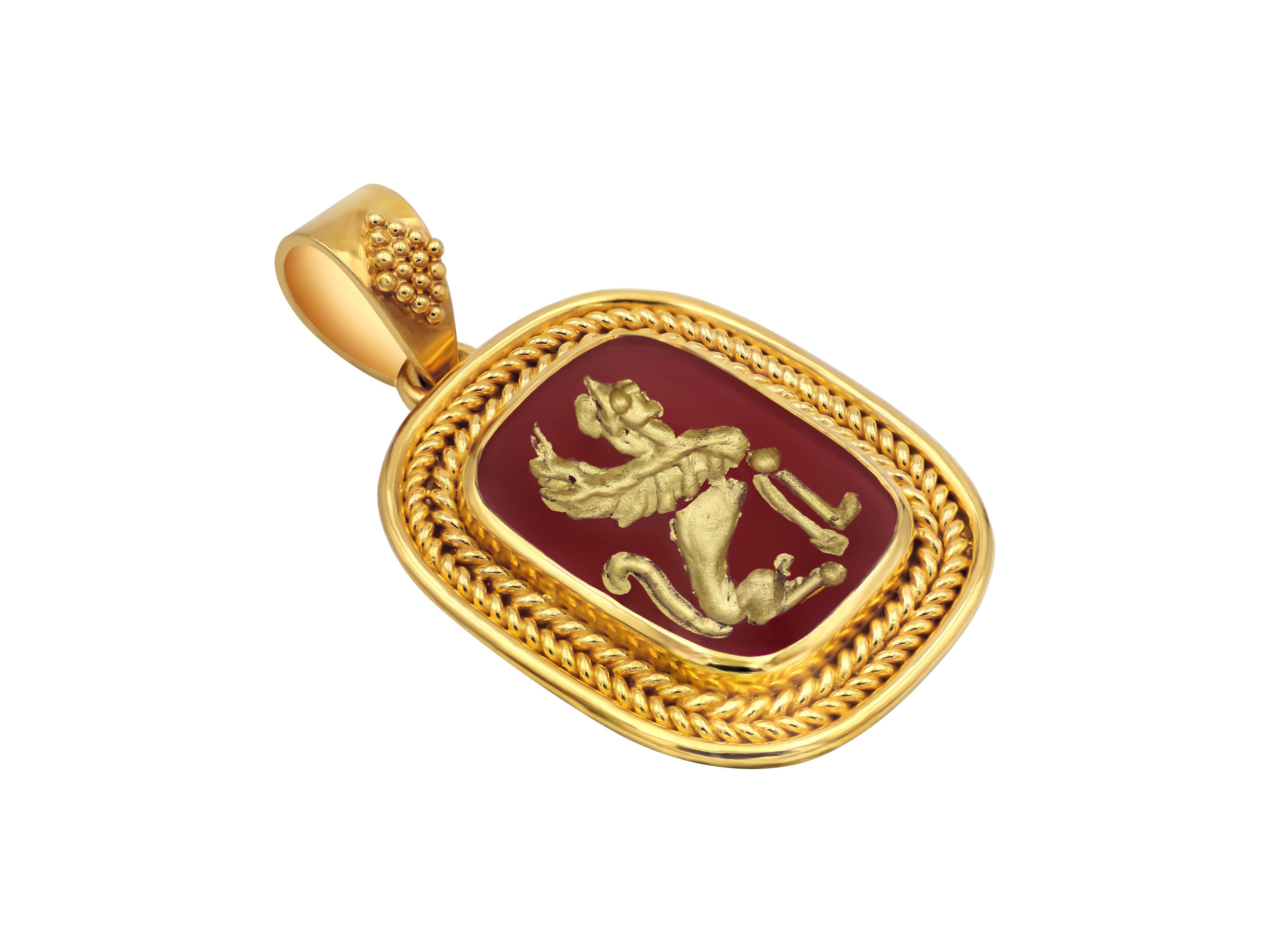 18k yellow gold pendant that follows precisely the museum guidelines with a fish bone wiring. The bezel is decorated with granulation and the Cornelian is carved showing the Sphinx. We have colored with gold paint the carving so it can really bring