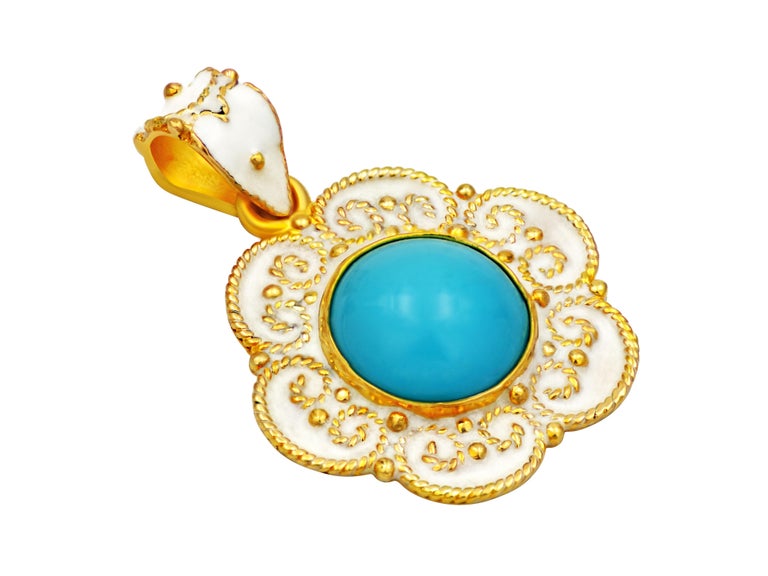 18k yellow gold framing this natural turquoise cut in round cabochon shape and decorate with white enamel to created the ultimate summer look, color and vibe.