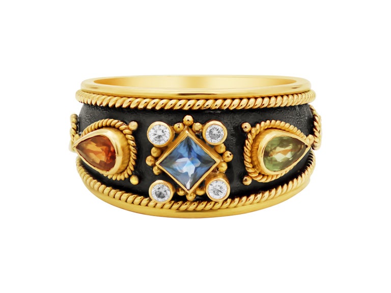 Noir collection ring all yellow gold 18k. The sweetest size with the biggest stones. Colorful sapphires and white diamonds give it a lot of  character in a very daily size. Filigrees and granulation mark the Byzantine era.